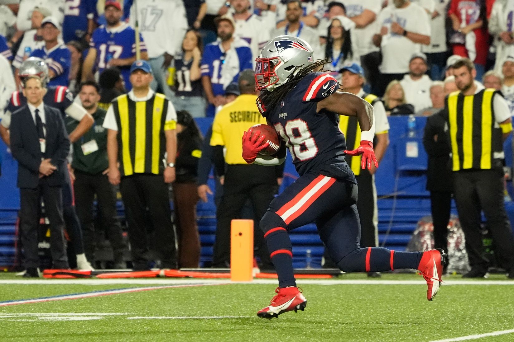 New England Patriots running back Rhamondre Stevenson (38) returns a kick off against the Buffalo Bills during the second half at Highmark Stadium.