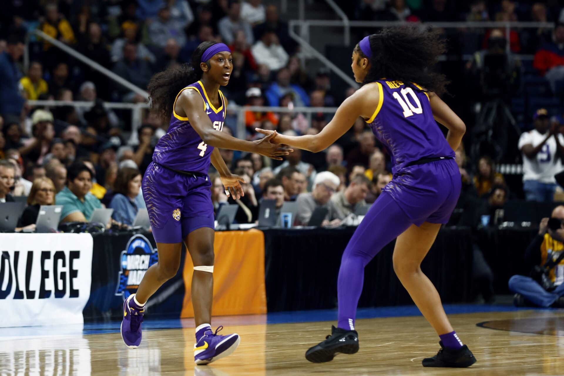 LSU Lady Tigers guard Flau'jae Johnson (4) and forward Angel Reese (10) react in the first quarter against the Iowa Hawkeyes in the finals of the Albany Regional in the 2024 NCAA Tournament at MVP Arena.