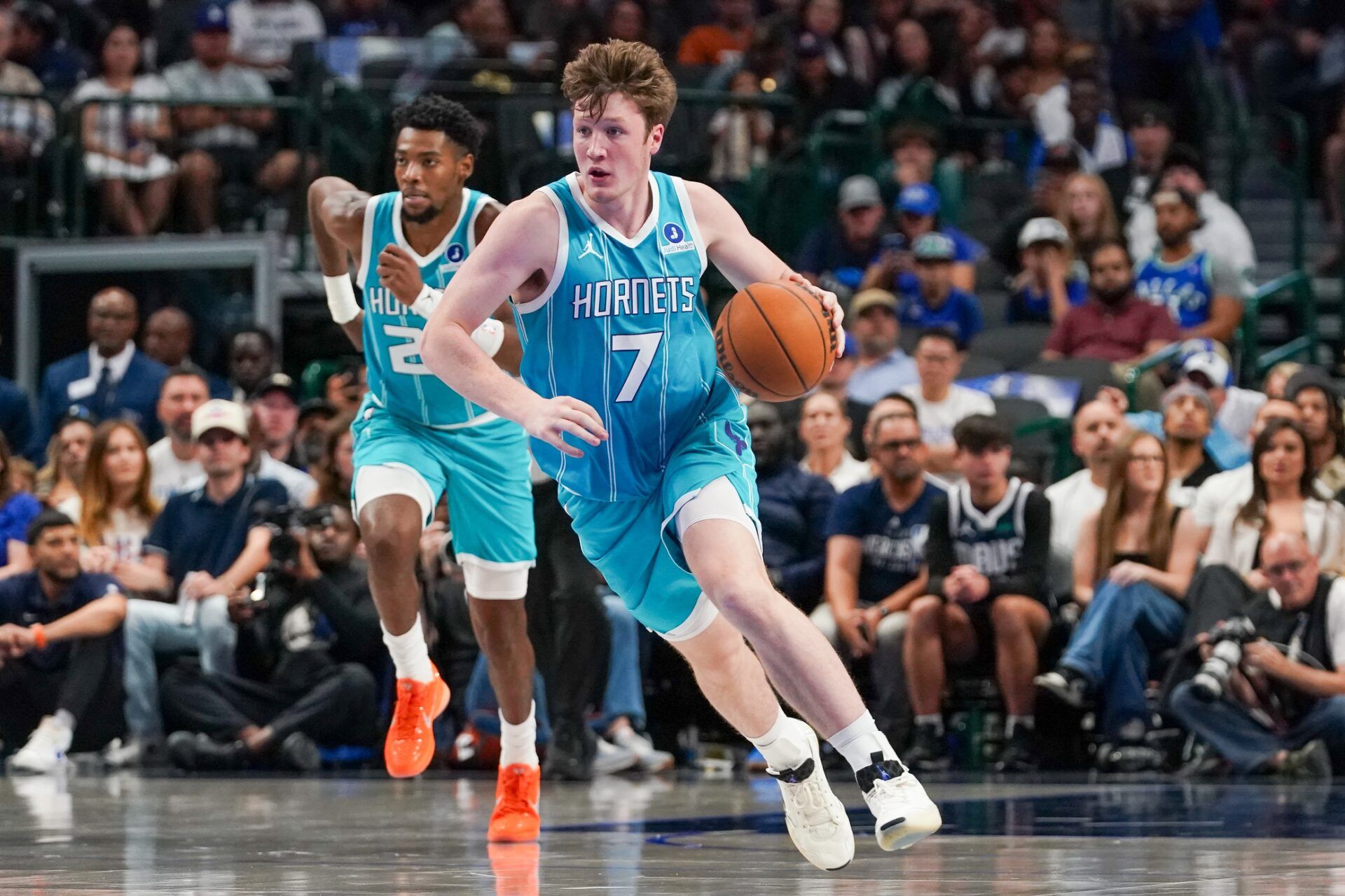 Charlotte Hornets guard/forward Kon Knueppel (7) dribbles up court in the first half of a game against the Dallas Mavericks at American Airlines Center.