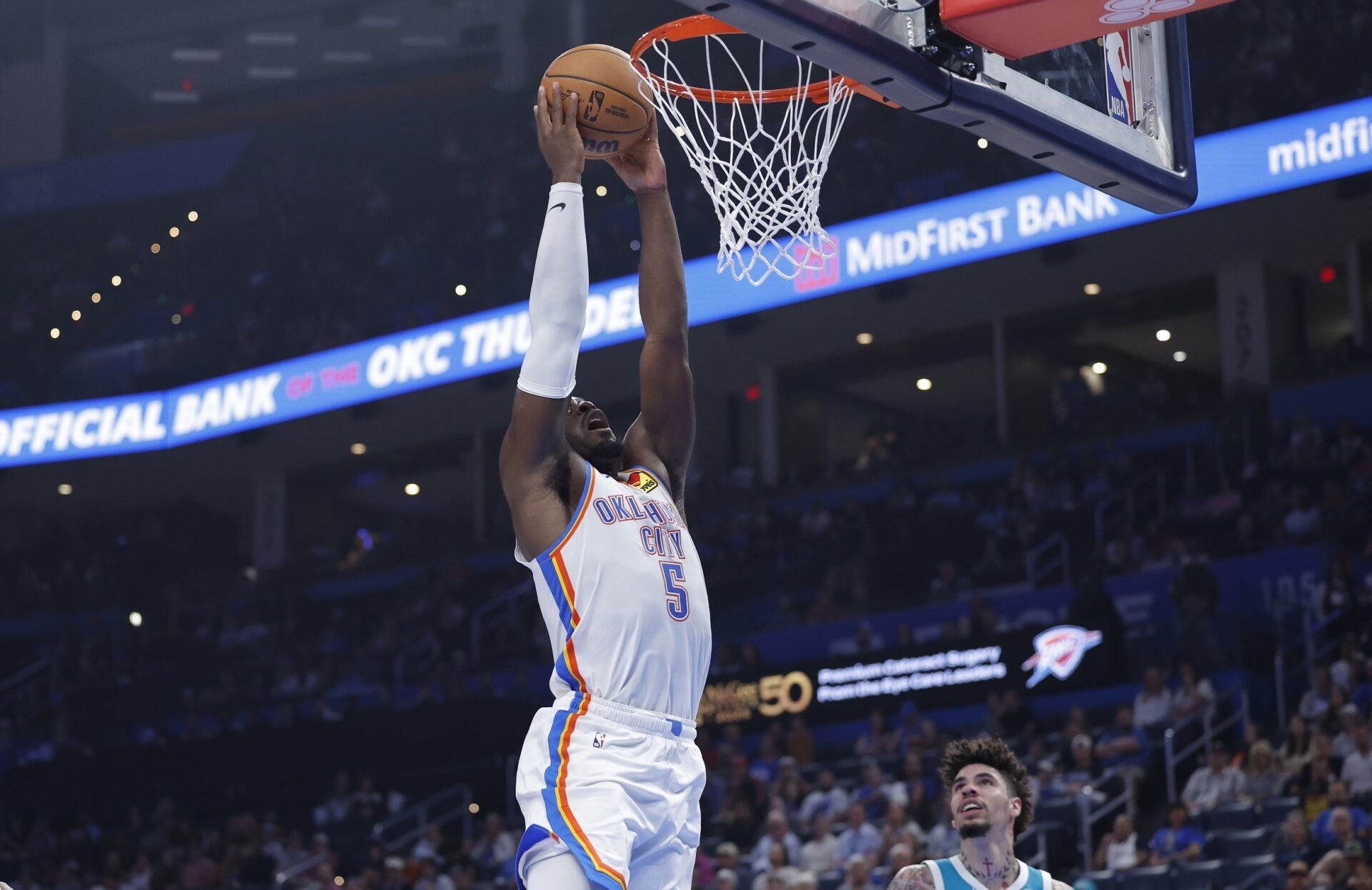 Oklahoma City Thunder guard Luguentz Dort (5) goes up for a dunk against the Charlotte Hornets during the second quarter of a game between the Charlotte Hornets and the Oklahoma City Thunder at Paycom Center.