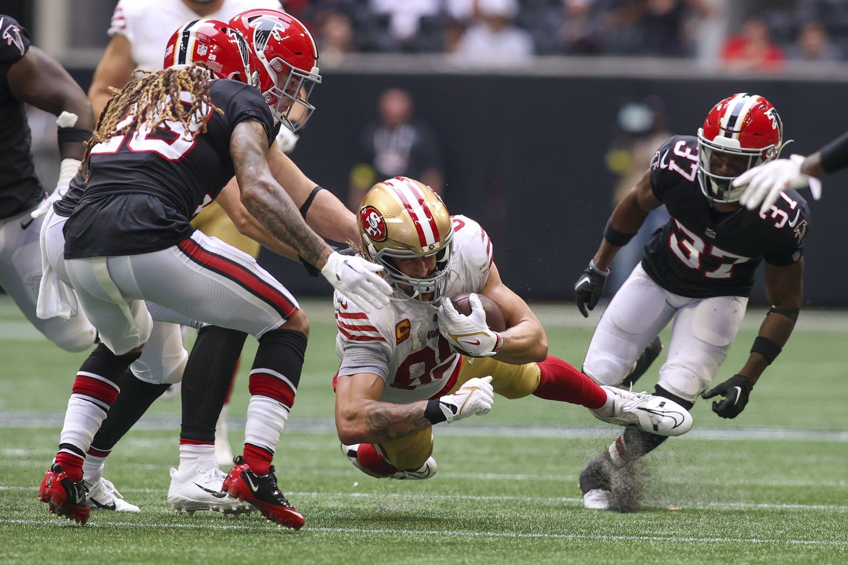 San Francisco 49ers tight end George Kittle (85) dives after a catch against the Atlanta Falcons in the second half at Mercedes-Benz Stadium.
