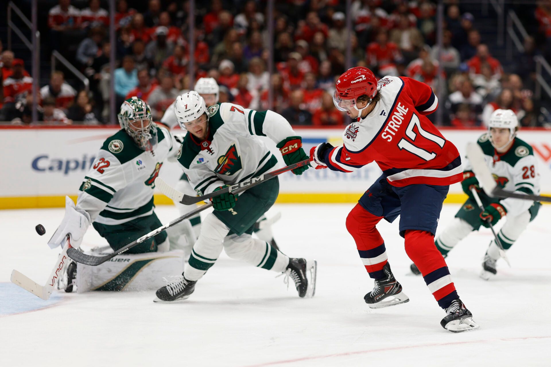 Washington Capitals center Dylan Strome (17) scores a goal on Minnesota Wild goaltender Filip Gustavsson (32) as Wild defenseman Brock Faber (7) defends during the third period at Capital One Arena.