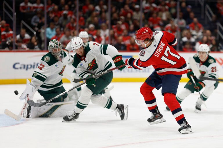 Washington Capitals center Dylan Strome (17) scores a goal on Minnesota Wild goaltender Filip Gustavsson (32) as Wild defenseman Brock Faber (7) defends during the third period at Capital One Arena.