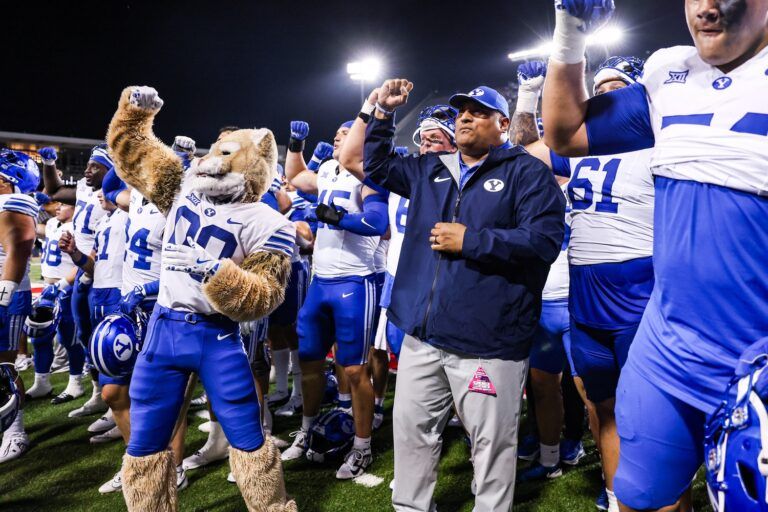 Brigham Young Cougars head coach Kalani Sitake celebrates a win against the Arizona Wildcats after overtime with his team and the crowd at Arizona Stadium.