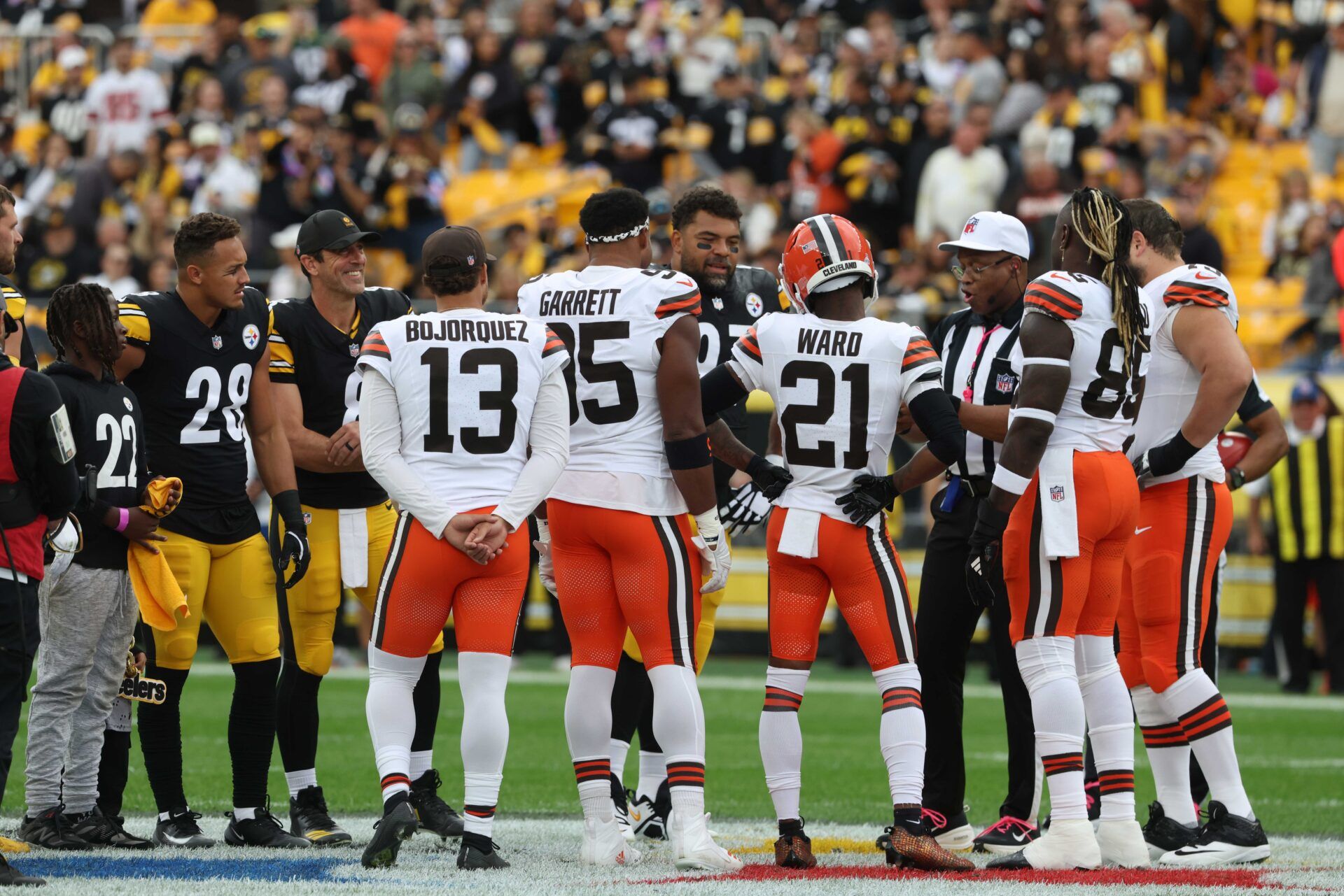 Pittsburgh Steelers safety Miles Killebrew (28) and quarterback Aaron Rodgers (8) and defensive tackle Cameron Heyward (97) participate in the coin toss against Cleveland Browns punter Corey Bojorquez (13) and defensive end Myles Garrett (95) and cornerback Denzel Ward (21) and tight end David Njoku (85) at Acrisure Stadium.