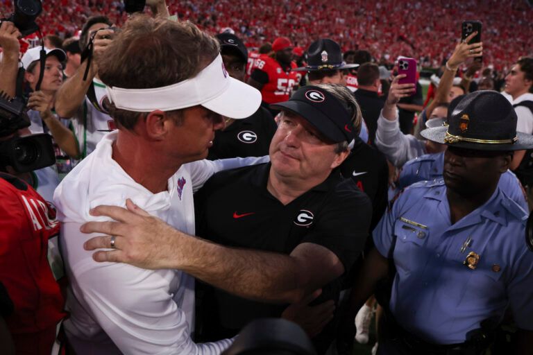 Georgia Bulldogs head coach Kirby Smart and Mississippi Rebels head coach Lane Kiffin meet on the field after the game at Sanford Stadium.