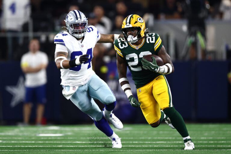 Green Bay Packers running back Emanuel Wilson (23) runs against Dallas Cowboys defensive end Marshawn Kneeland (94) in the first quarter at AT&T Stadium.