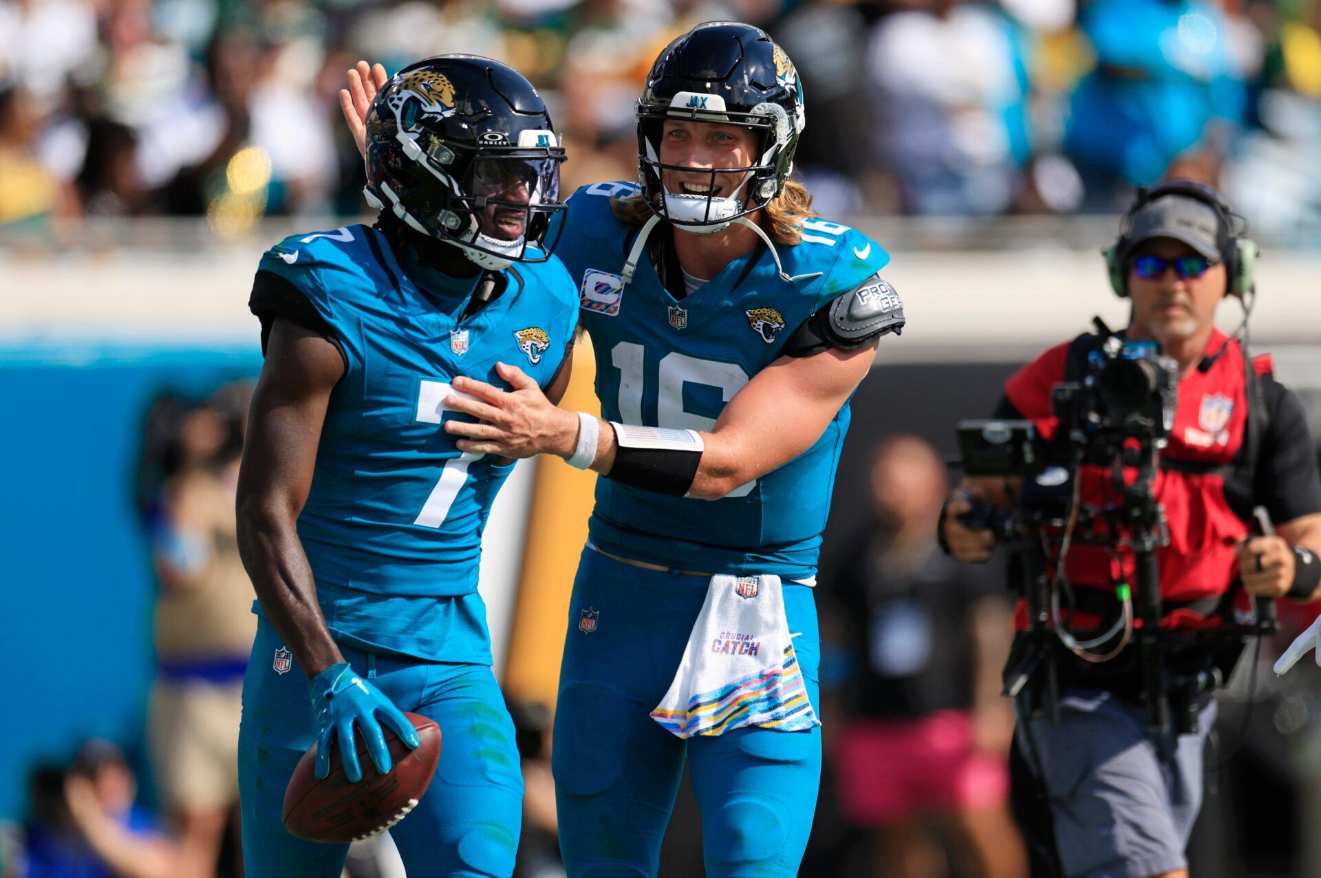 Jacksonville Jaguars quarterback Trevor Lawrence (16) congratulates wide receiver Brian Thomas Jr. (7) on his touchdown score during the third quarter of an NFL football matchup Sunday, Oct. 27, 2024 at EverBank Stadium in Jacksonville, Fla. The Packers edged the Jaguars 30-27 on a last-second field goal. [Corey Perrine/Florida Times-Union]