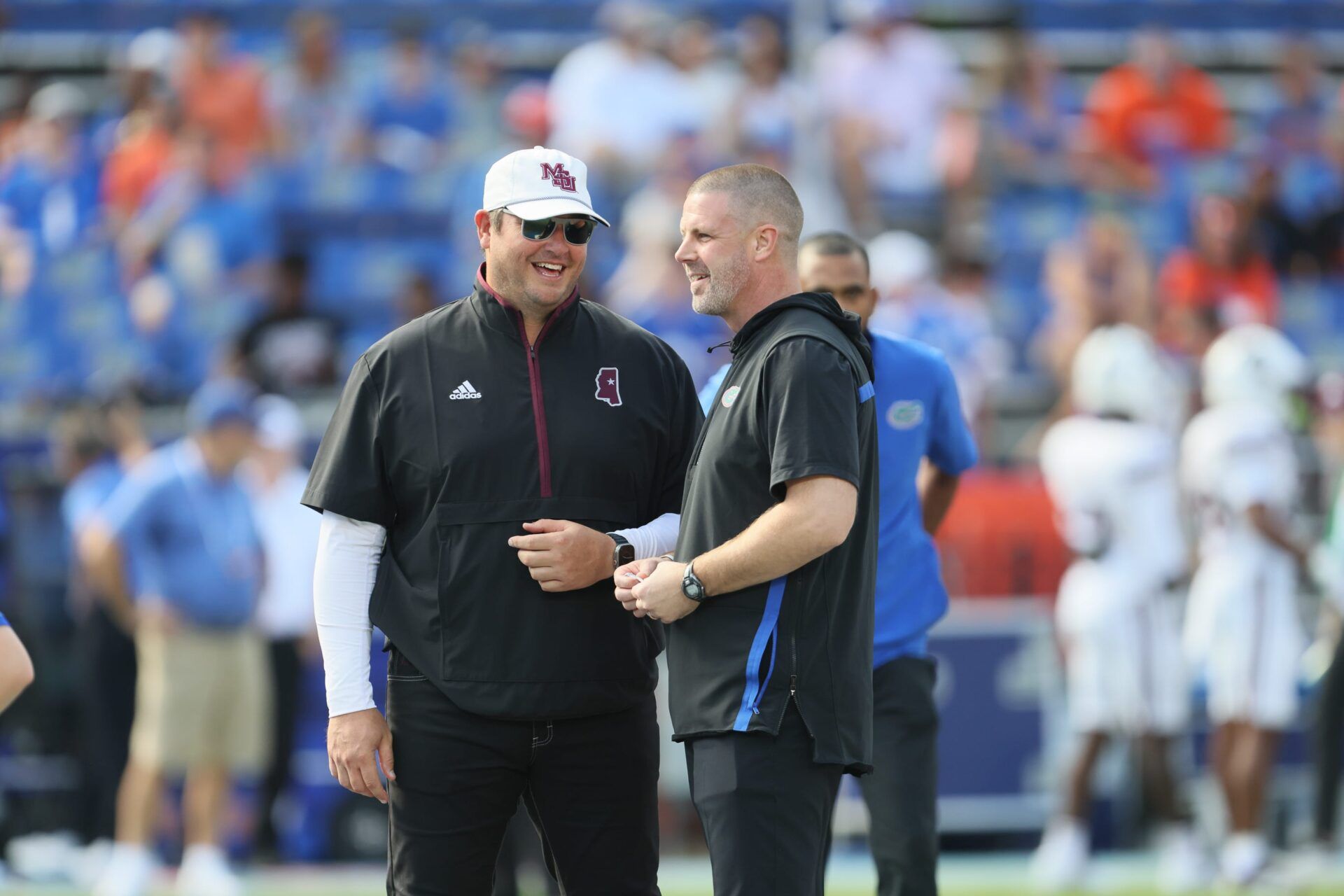 Florida head coach Billy Napier, right, and Mississippi State head coach Jeff Lebby chat Florida quarterback Tramell Jones Jr. (17) before an NCAA football game at Steve Spurrier Field at Ben Hill Griffin Stadium in Gainesville, FL on Saturday, October 18, 2025. [Alan Youngblood/Gainesville Sun]
