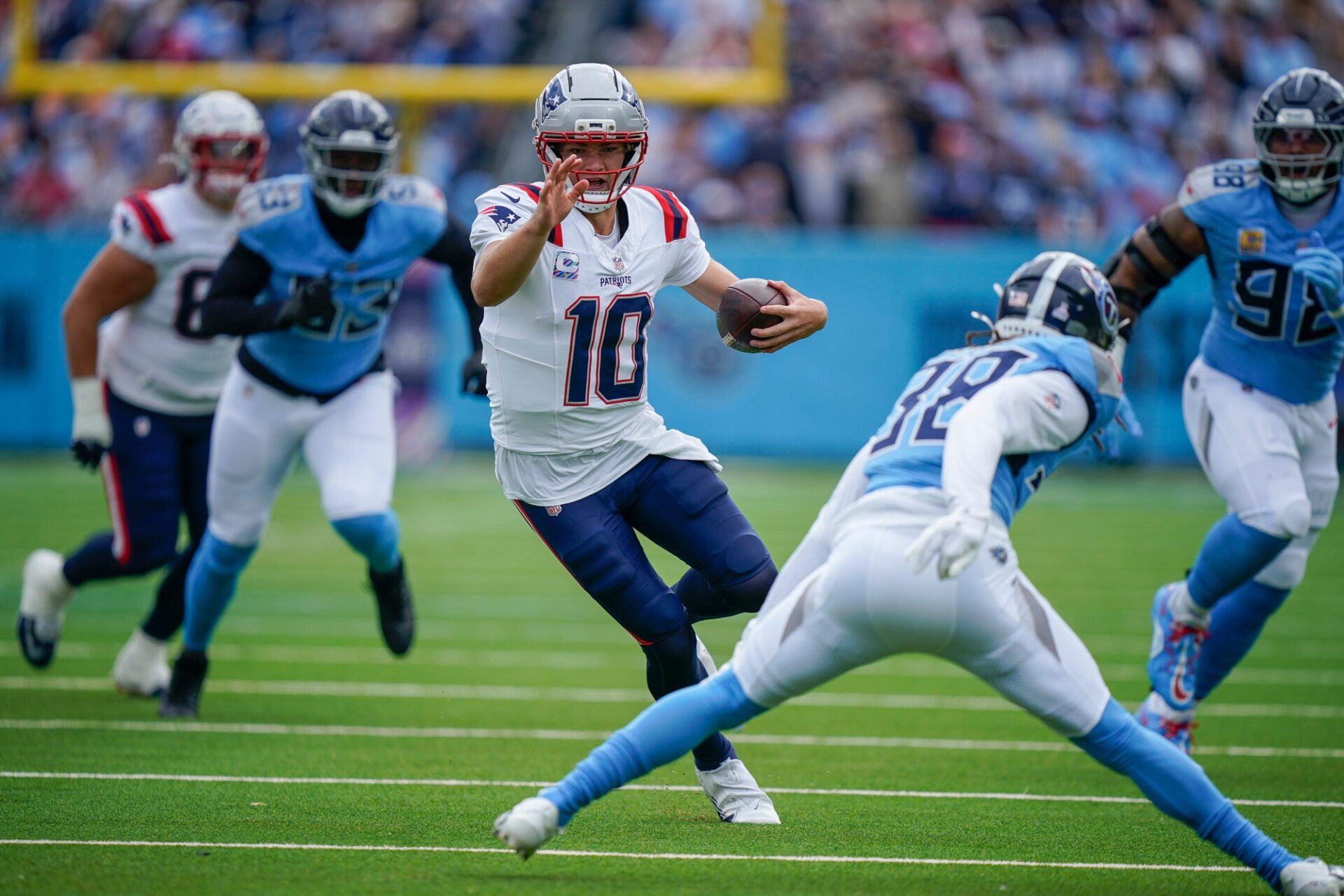 New England Patriots quarterback Drake Maye (10) scrambles against the New England Patriots during the first quarter at Nissan Stadium in Nashville, Tenn., Sunday, Oct. 19, 2025.