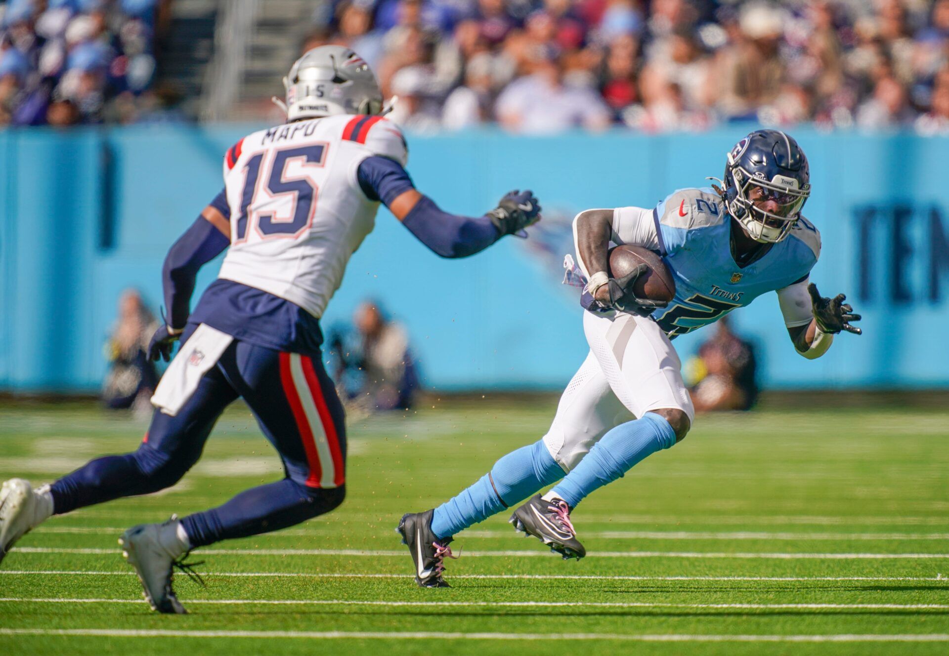 Tennessee Titans running back Tyjae Spears (2) tries to evade New England Patriots linebacker Marte Mapu (15) during the fourth quarter at Nissan Stadium in Nashville, Tenn., Sunday, Oct. 19, 2025.