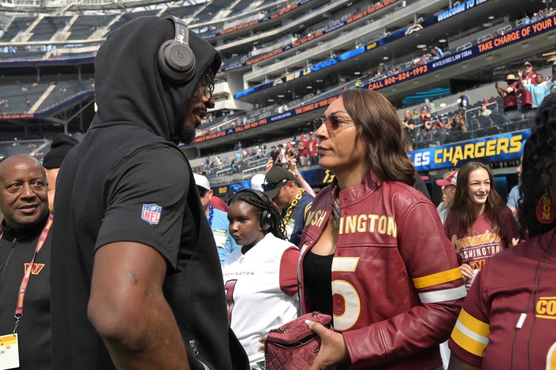 Washington Commanders quarterback Jayden Daniels (5) talks with his mom, Regina Jackson, prior to the game against the Los Angeles Chargers at SoFi Stadium.