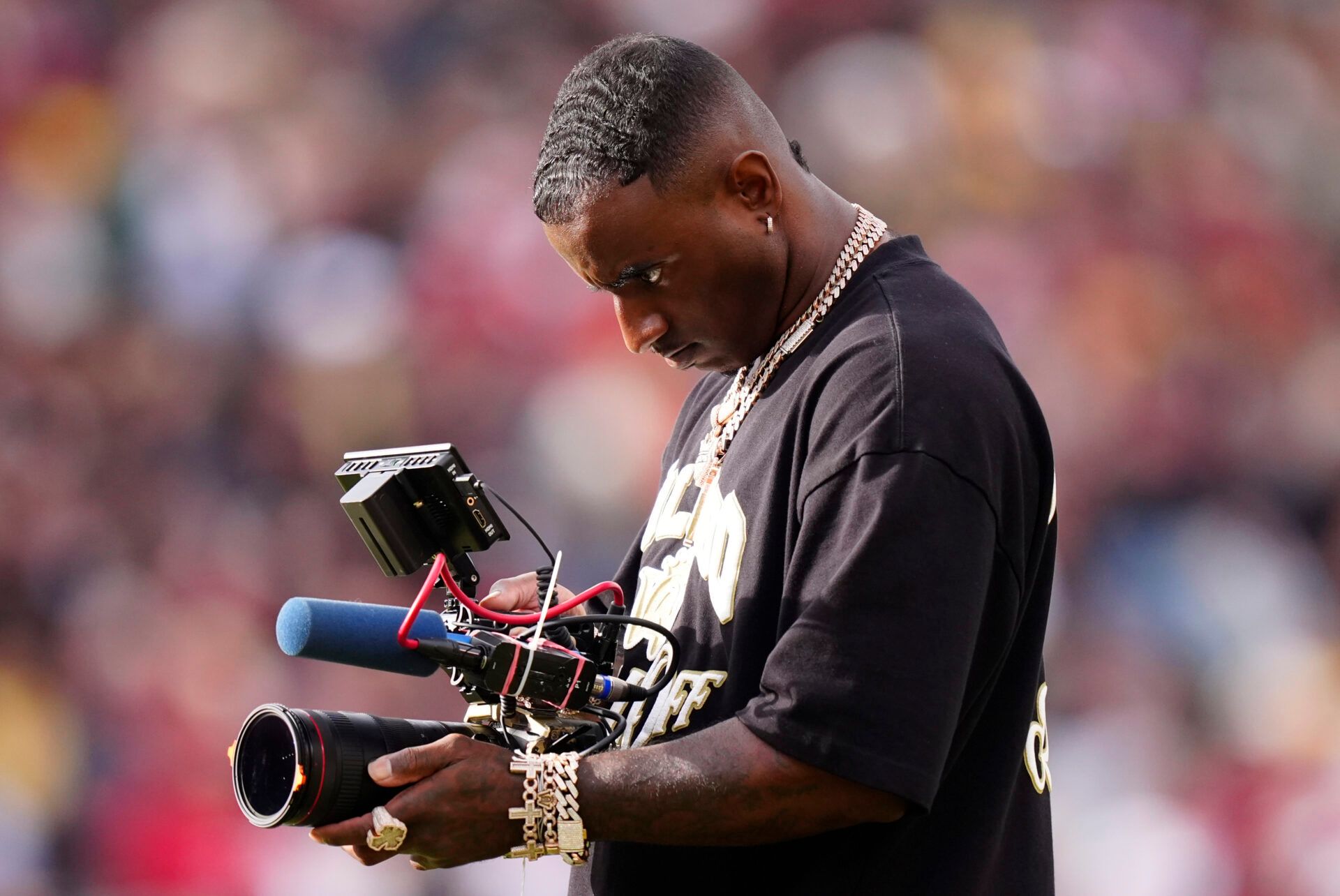 Colorado Buffaloes Deion Sanders Jr. records the game against the Iowa State Cyclones during the second half at Folsom Field.