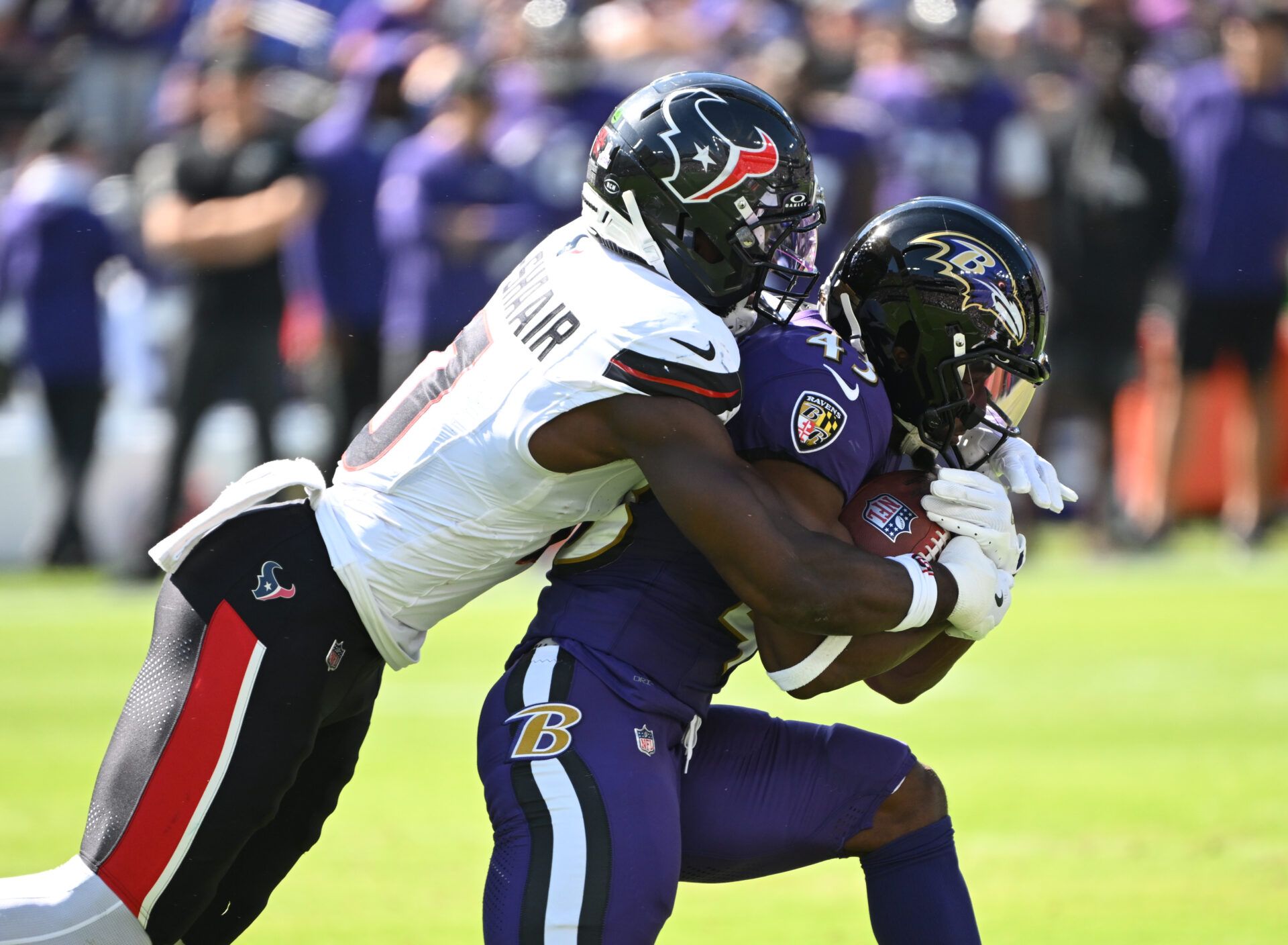 Baltimore Ravens running back Justice Hill (43) is tackled by Houston Texans linebacker Azeez al-Shaair (0) during the first quarter at M&T Bank Stadium.