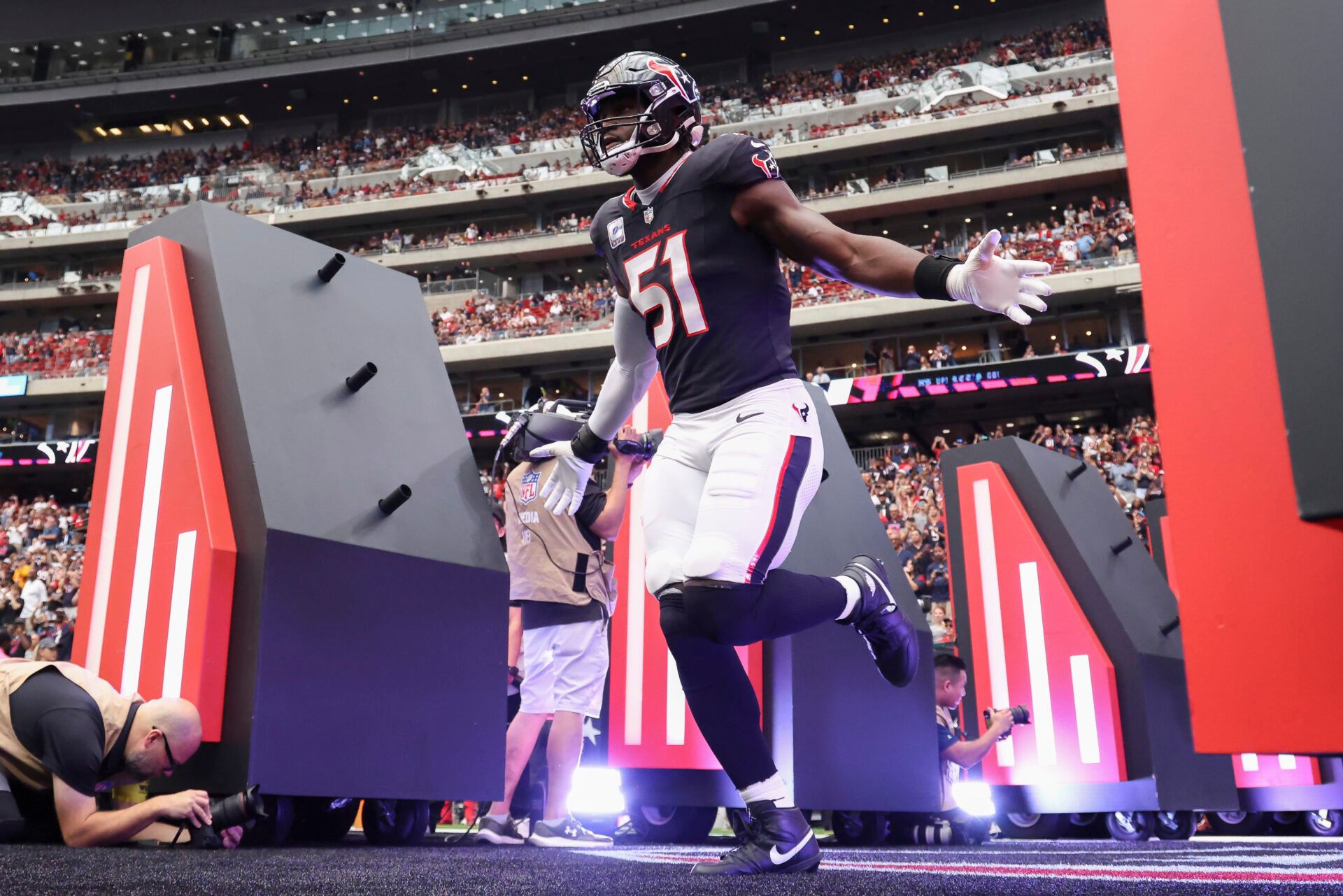 Houston Texans defensive end Will Anderson Jr. (51) runs onto the field before the game against the Tennessee Titans at NRG Stadium.
