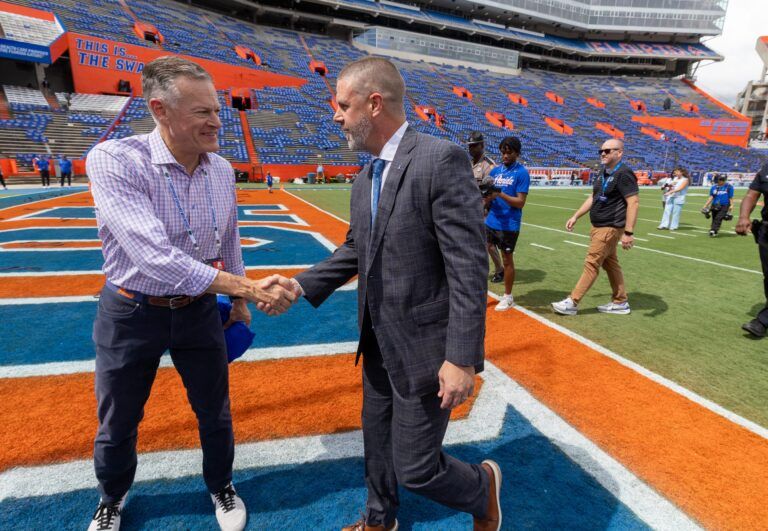 Florida Athletic Director Scott Strickland greet Florida head coach Billy Napier during gator walk before an NCAA football game Texas in Gainesville, FL on Saturday, October 4, 2025. [Alan Youngblood/Gainesville Sun]