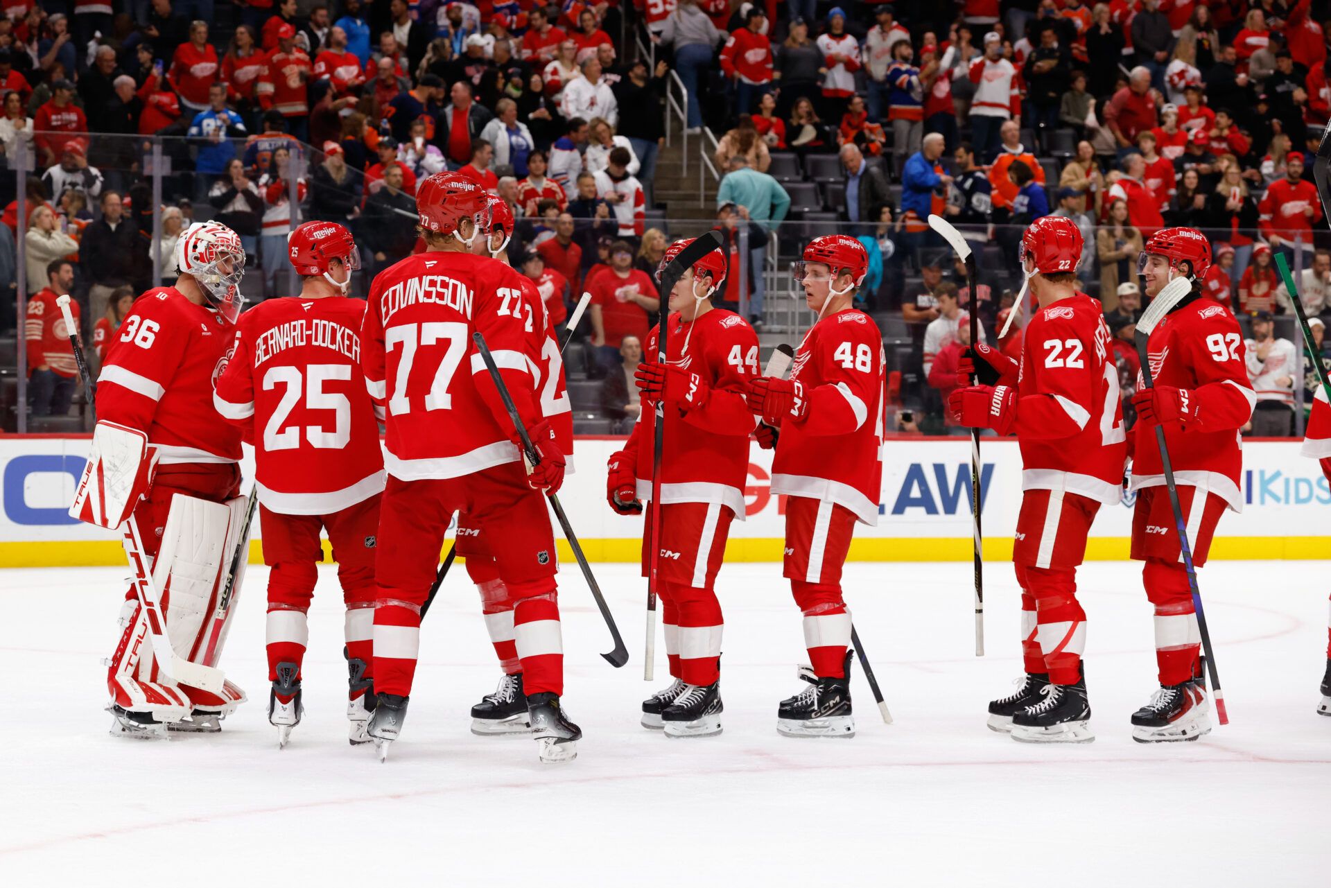 Detroit Red Wings players celebrate on the ice after defeating the Edmonton Oilers at Little Caesars Arena.
