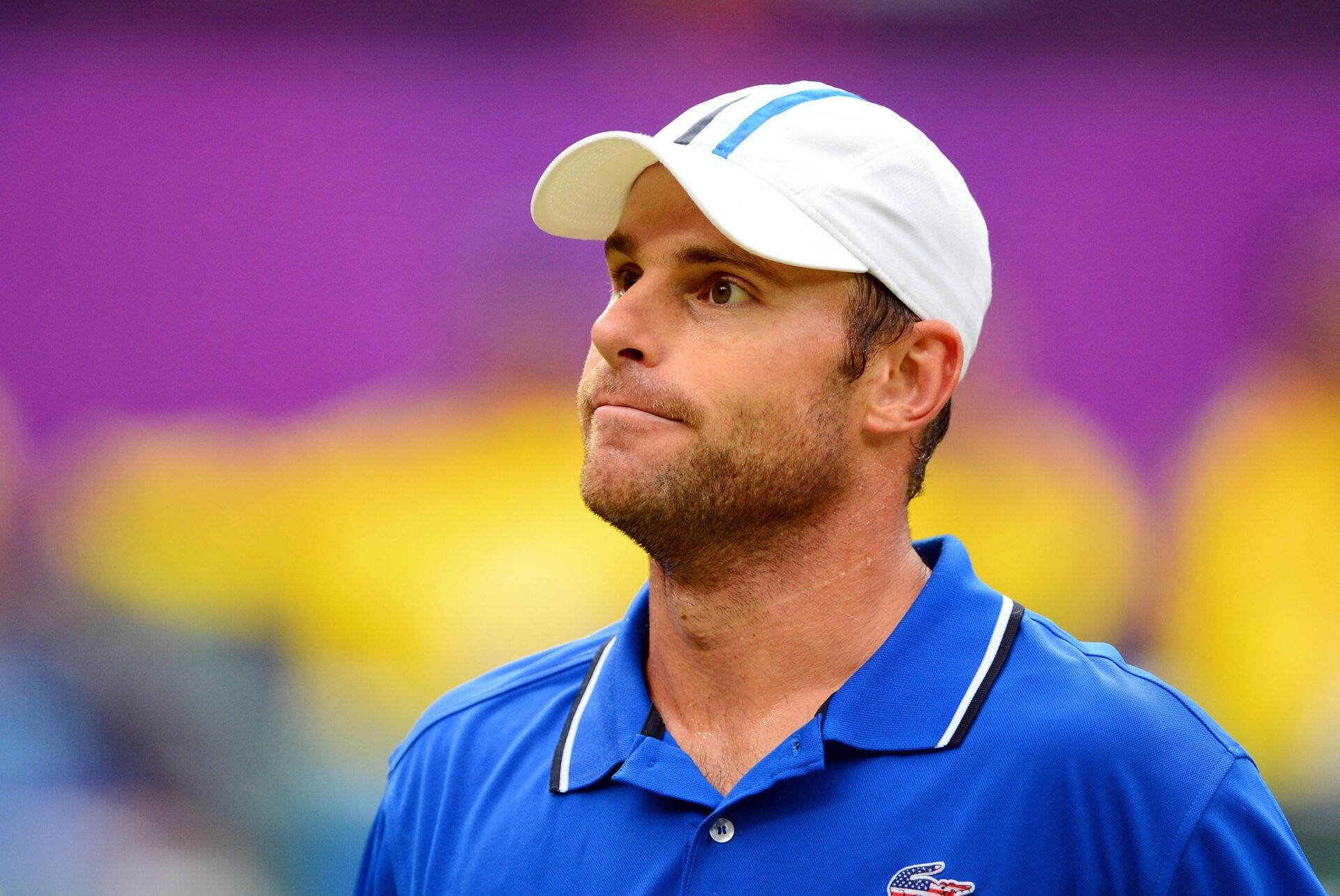 Andy Roddick (USA) reacts after losing a point to Novak Djokovic (SVK) during a match in the second round of the men's singles during the London 2012 Olympic Games at Wimbledon.