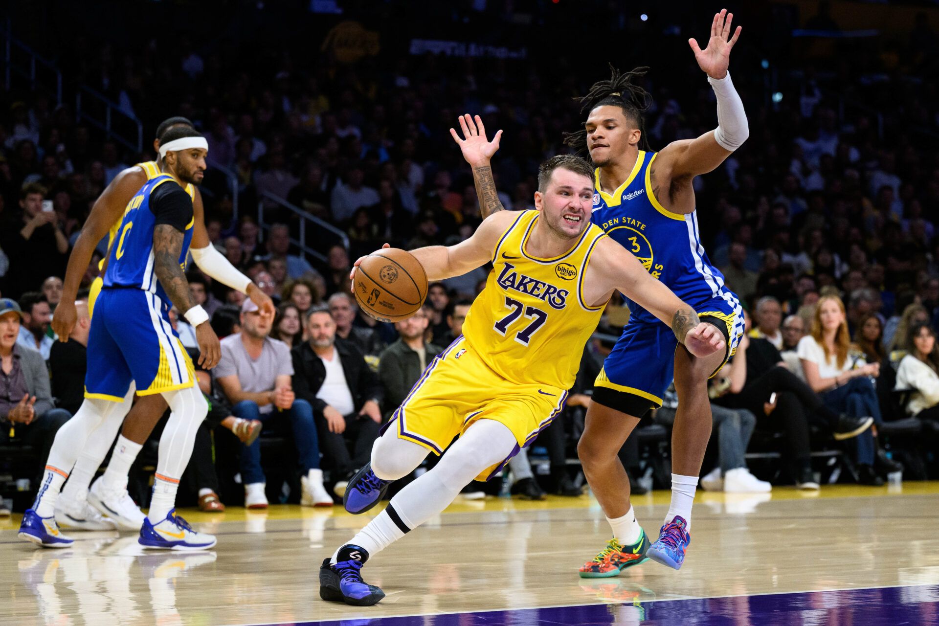 Los Angeles Lakers guard Luka Doncic (77) drives past Golden State Warriors guard Will Richard (3) during the first half at Crypto.com Arena.