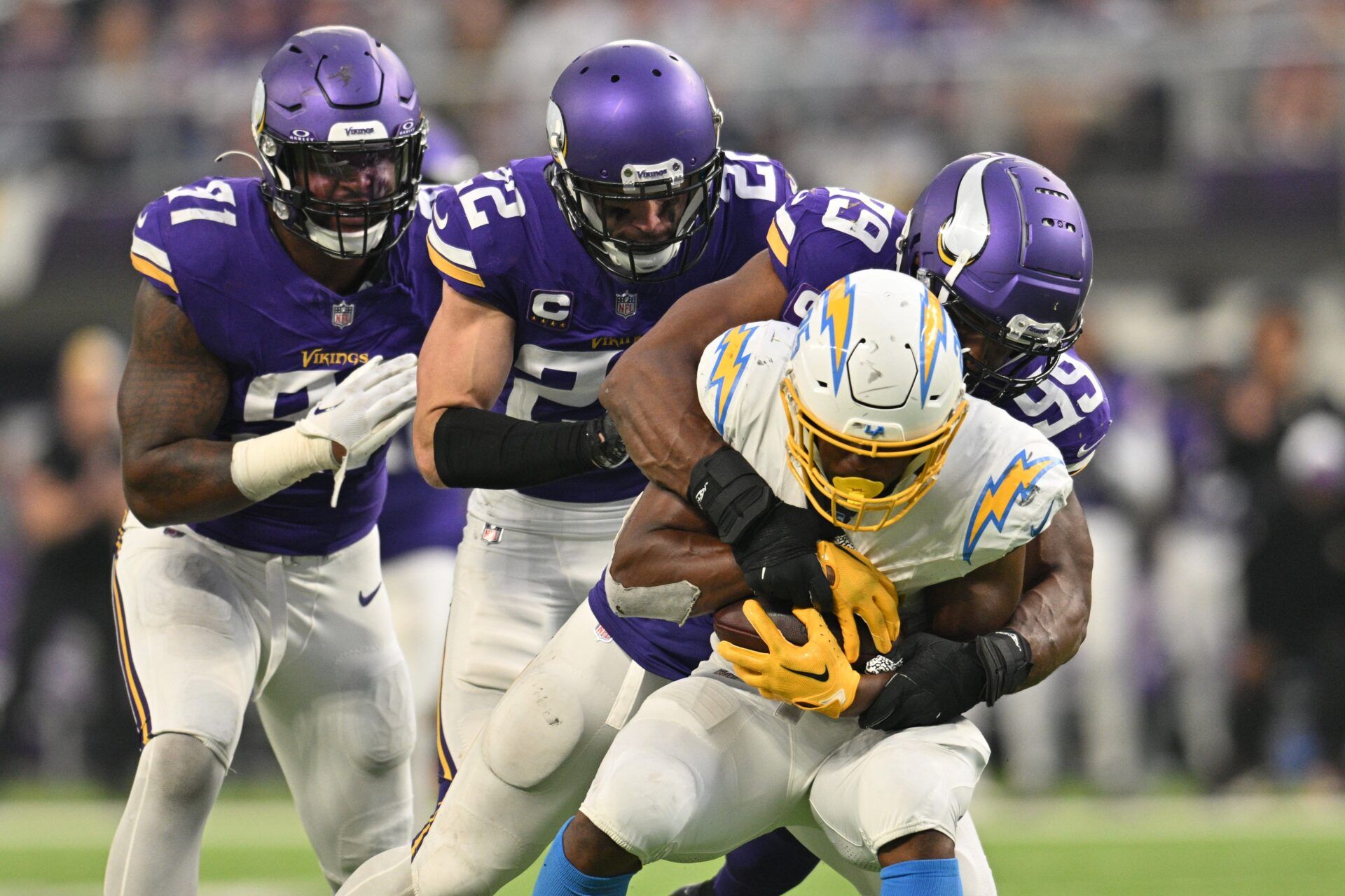 Los Angeles Chargers running back Joshua Kelley (25) is tackled by Minnesota Vikings linebacker Danielle Hunter (99) and assisted by safety Harrison Smith (22) and linebacker Pat Jones II (91)during the fourth quarter at U.S. Bank Stadium.
