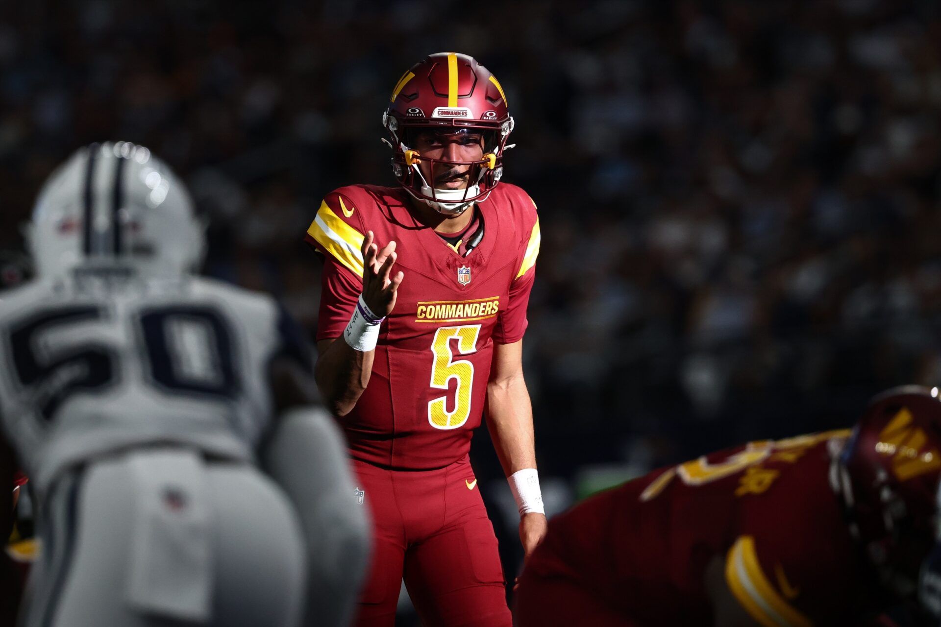 Washington Commanders quarterback Jayden Daniels (5) calls a play at the line of scrimmage against the Dallas Cowboys =d2q of the game at AT&T Stadium.