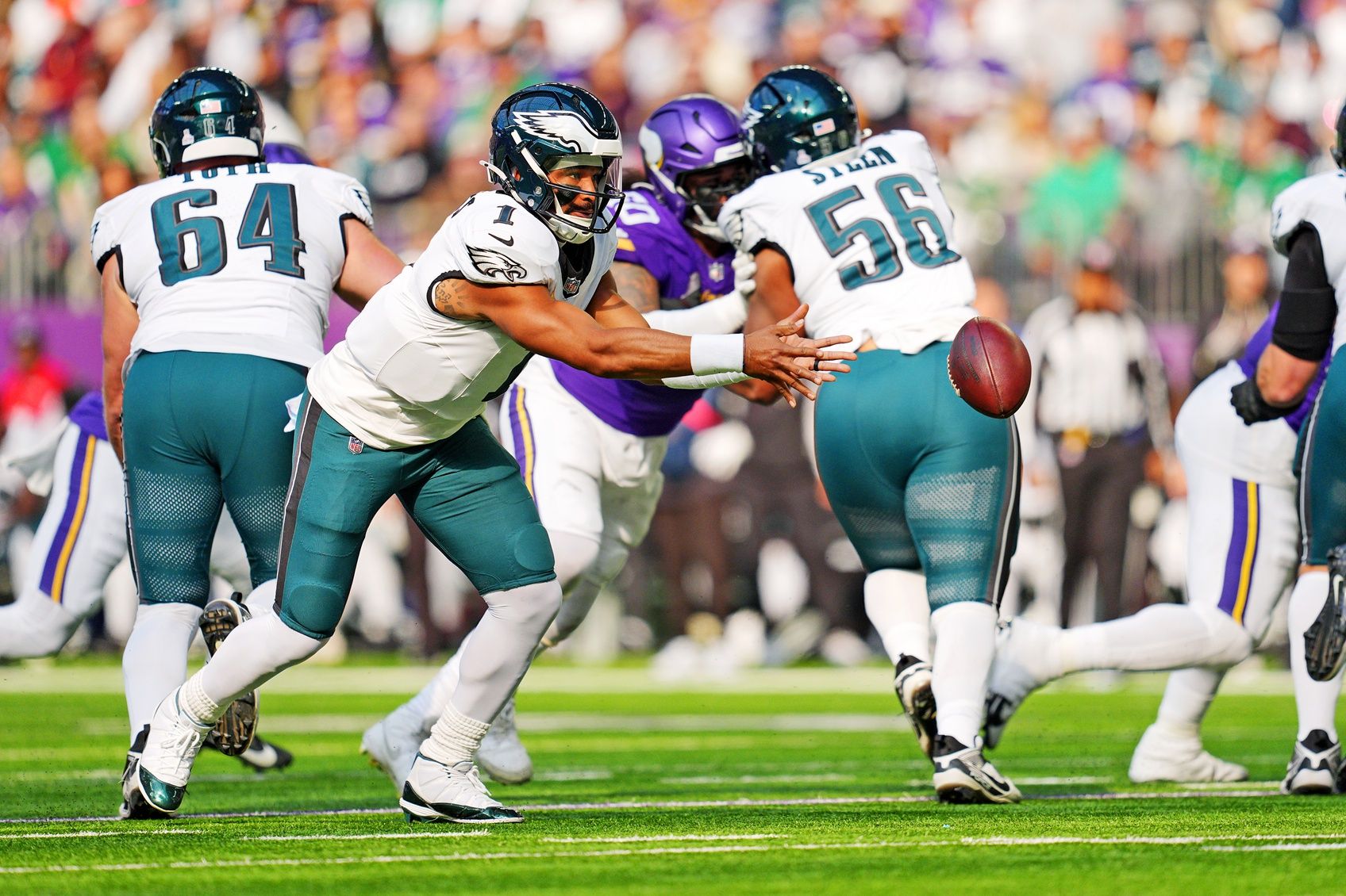 Philadelphia Eagles quarterback Jalen Hurts (1) runs for a pass during the second half against the Minnesota Vikings at U.S. Bank Stadium.