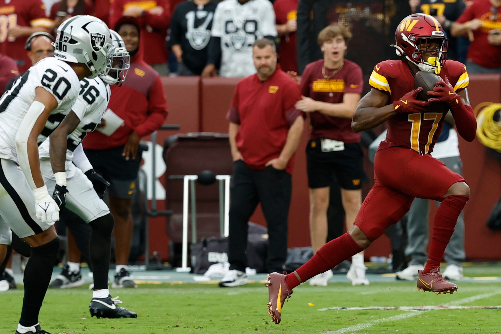 Washington Commanders wide receiver Terry McLaurin (17) catches a pass in front of Las Vegas Raiders safety Isaiah Pola-Mao (20) and Raiders cornerback Kyu Blu Kelly (36) at Northwest Stadium.