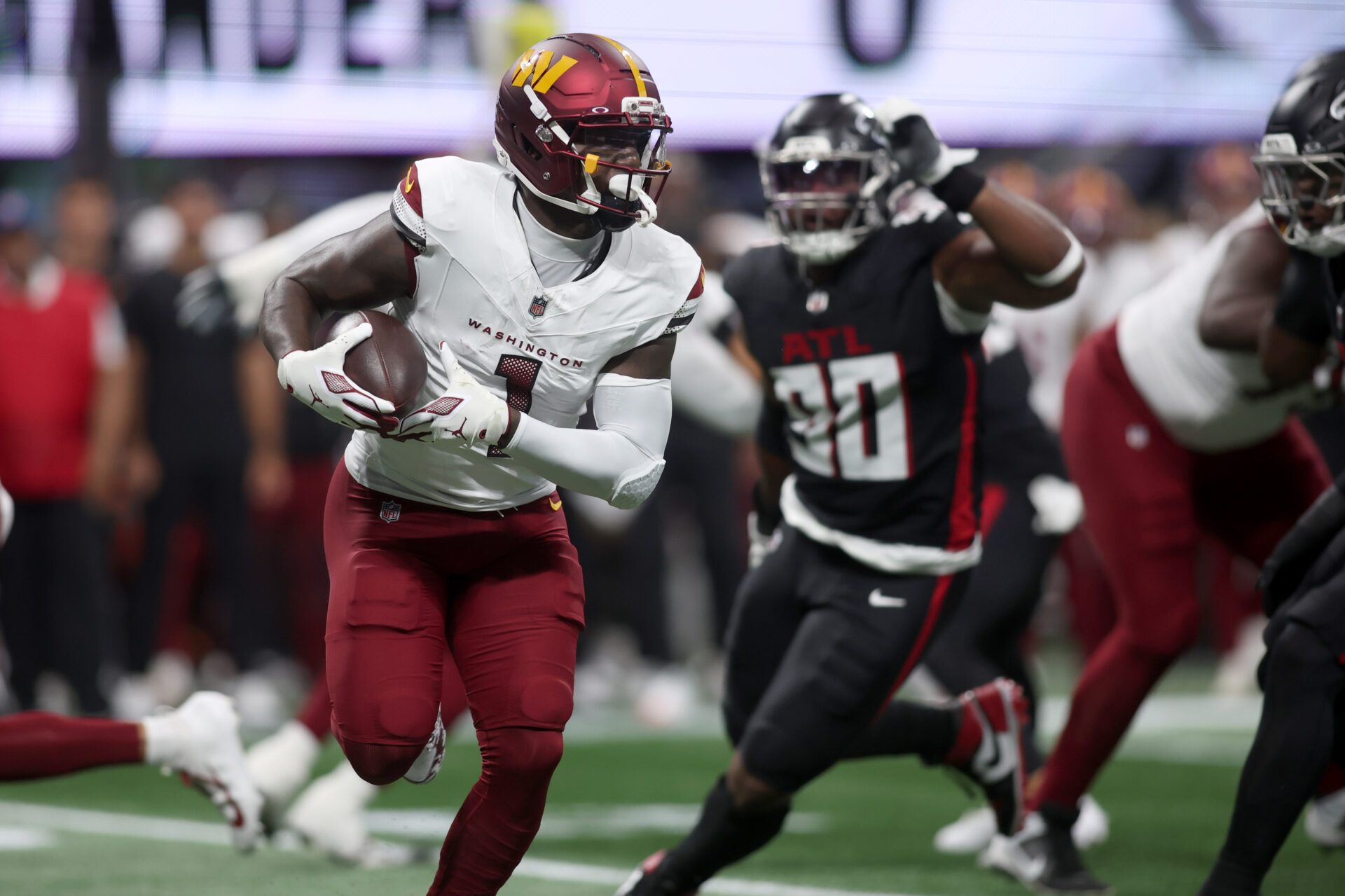 Washington Commanders wide receiver Deebo Samuel Sr. (1) runs during the first quarter against the Atlanta Falcons at Mercedes-Benz Stadium.