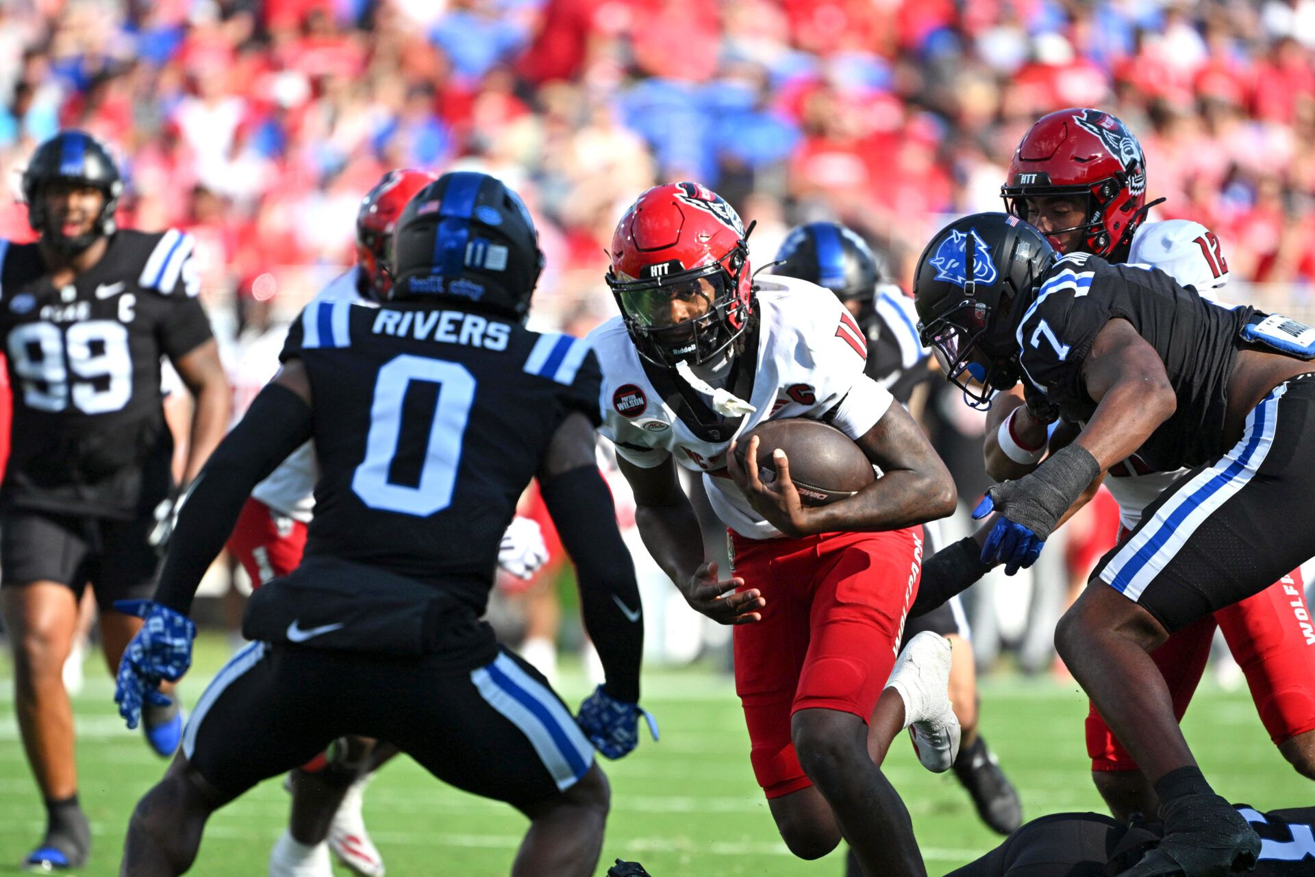 North Carolina State Wolfpack quarter back CJ Bailey (11) runs the ball against Duke Blue Devils cornerback Chandler Rivers (0) during the first quarter at Wallace Wade Stadium.