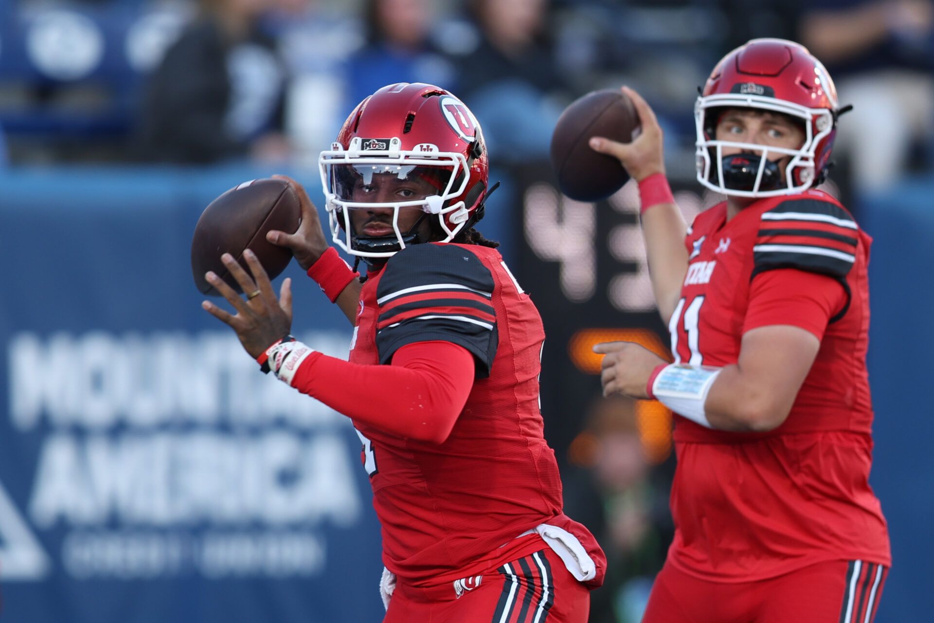 Utah Utes quarterback Devon Dampier (4) and quarterback Isaac Wilson (11) warm up before the game against the BYU Cougars at LaVell Edwards Stadium.