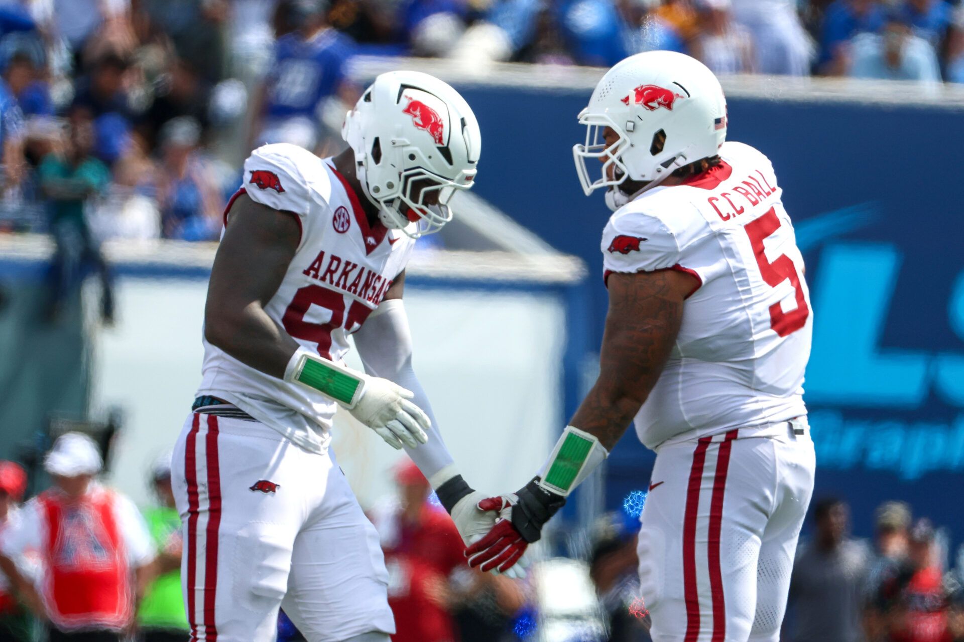 Arkansas Razorbacks defensive linemen Quincy Rhodes Jr. (97) and Cameron Ball (5) celebrate a stop against the Memphis Tigers during the second half at Simmons Bank Liberty Stadium.