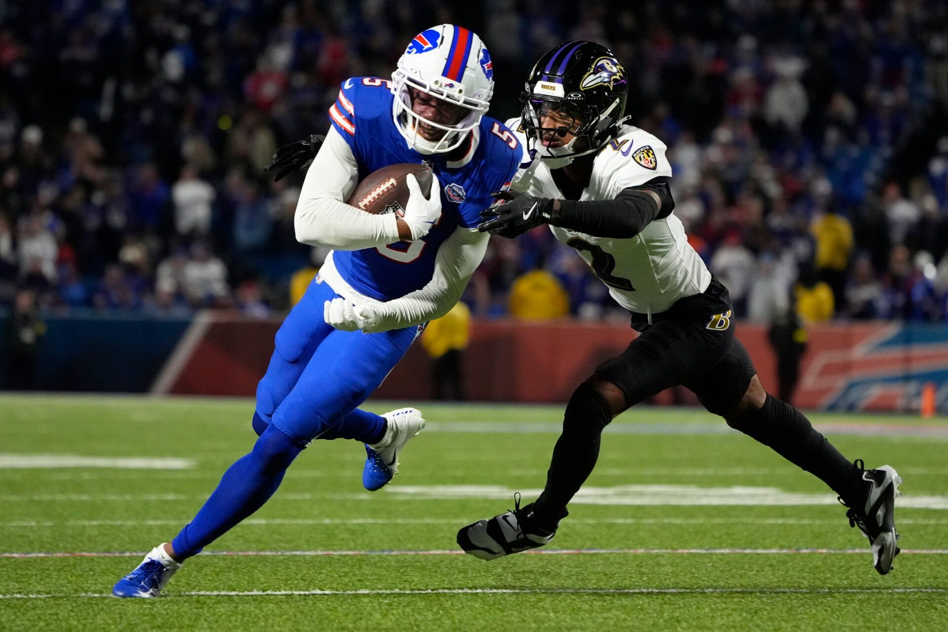 Buffalo Bills wide receiver Joshua Palmer (5) runs the ball against Baltimore Ravens cornerback Nate Wiggins (2) during the fourth quarter at Highmark Stadium.