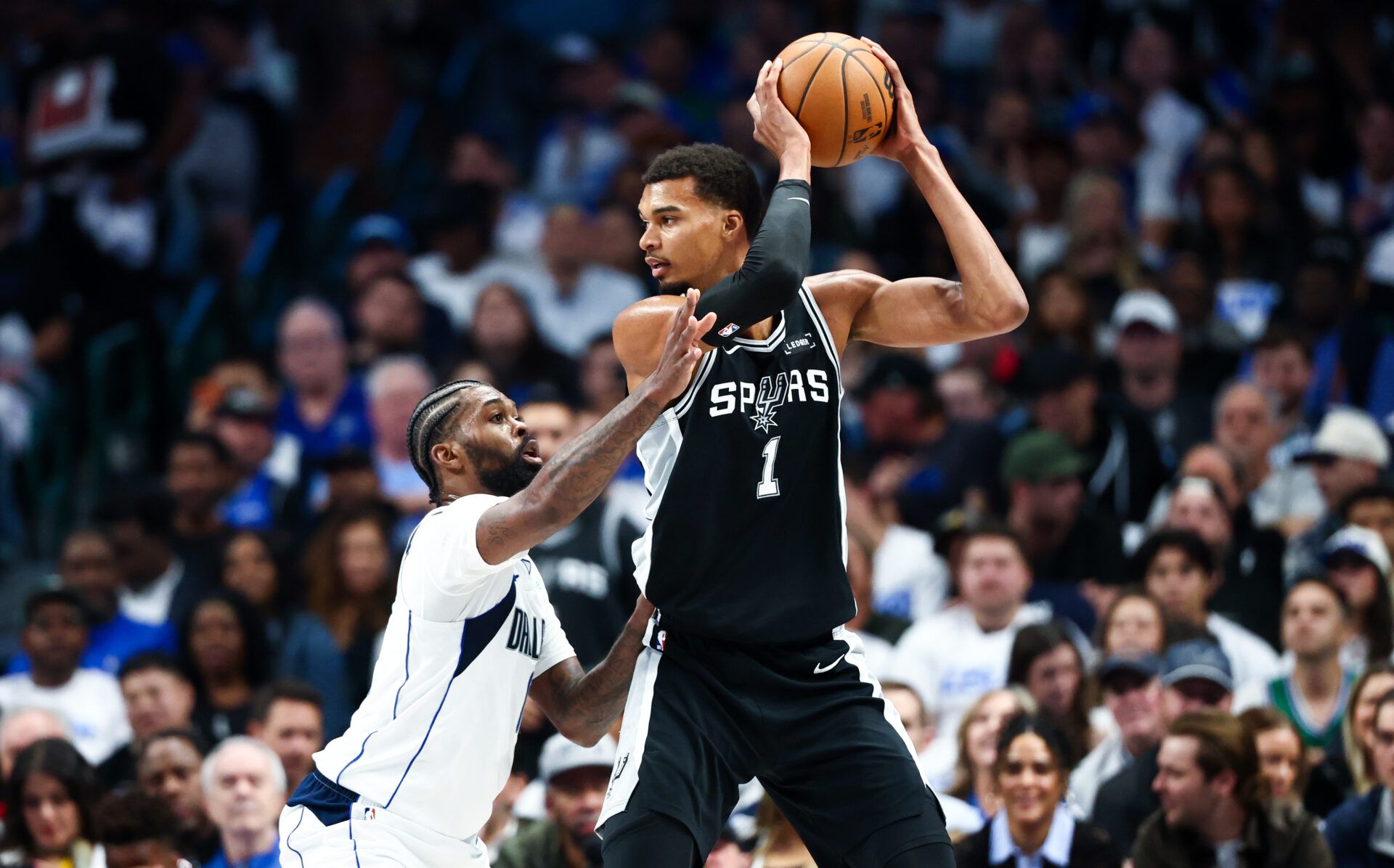 San Antonio Spurs forward Victor Wembanyama (1) looks to score as Dallas Mavericks forward Naji Marshall (13) defends during the first half  at American Airlines Center.