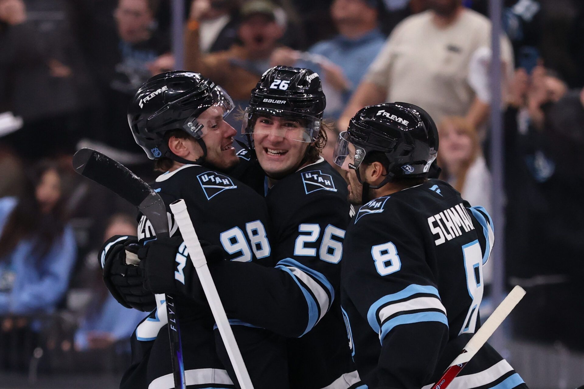 Utah Mammoth defenseman Mikhail Sergachev (98) celebrates scoring a goal against the Colorado Avalanche with defenseman Dmitri Simashev (26) and center Nick Schmaltz (8) during the third period at Delta Center.