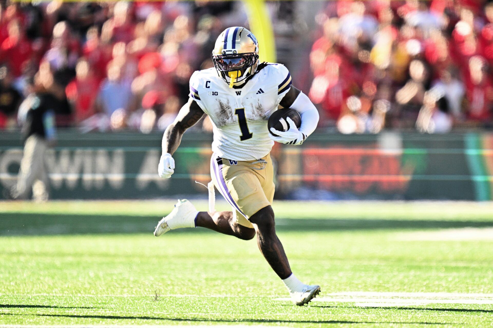 Washington Huskies running back Jonah Coleman (1) carries the ball against the Maryland Terrapins at SECU Stadium.