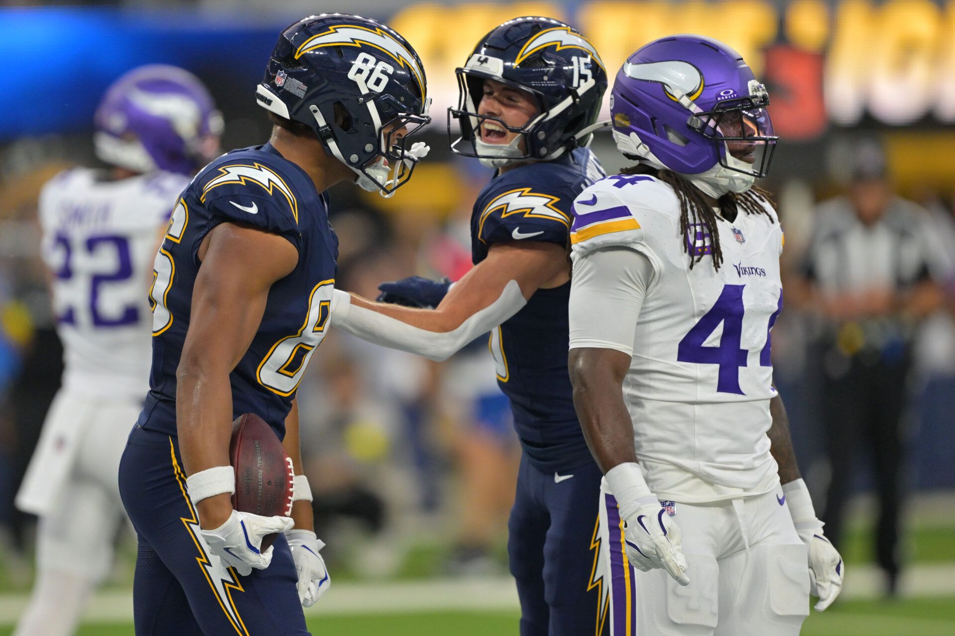 Los Angeles Chargers tight end Oronde Gadsden II (86) reacts after making a touchdown catch with wide receiver Ladd McConkey (15) during the first half at SoFi Stadium.