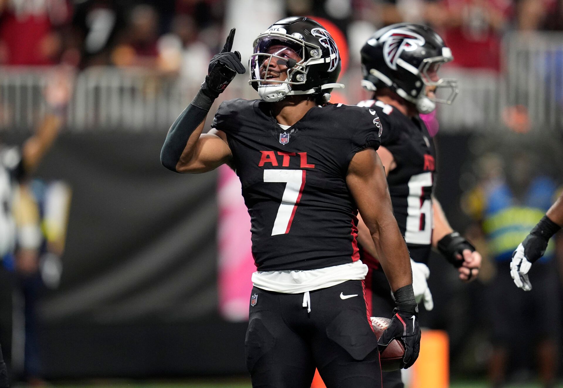 Atlanta Falcons running back Bijan Robinson (7) celebrates after scoring a touchdown during the first half against the Washington Commanders at Mercedes-Benz Stadium.