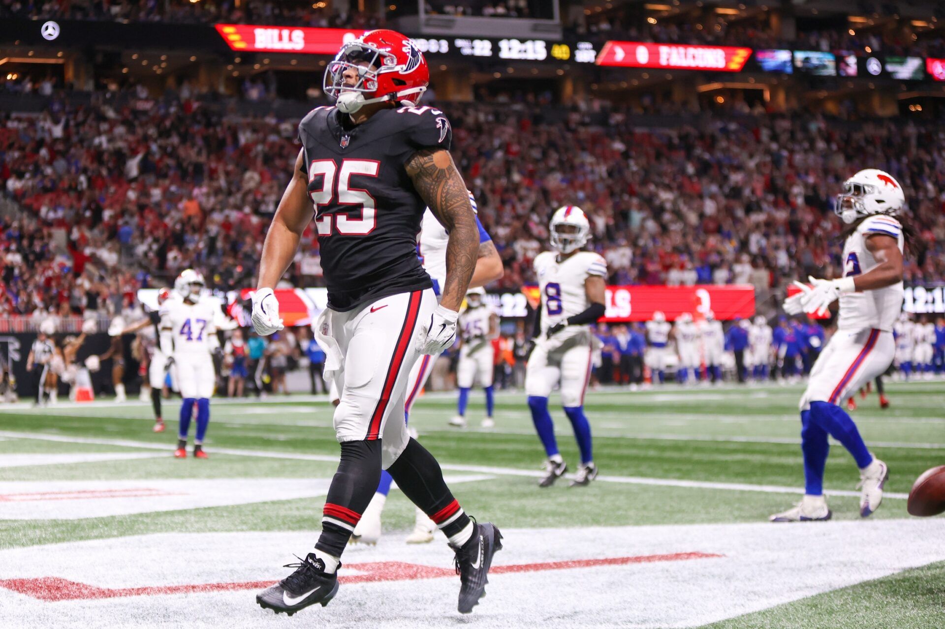 Atlanta Falcons running back Tyler Allgeier (25) reacts after scoring a touchdown against the Buffalo Bills during the first half of a game at Mercedes-Benz Stadium.