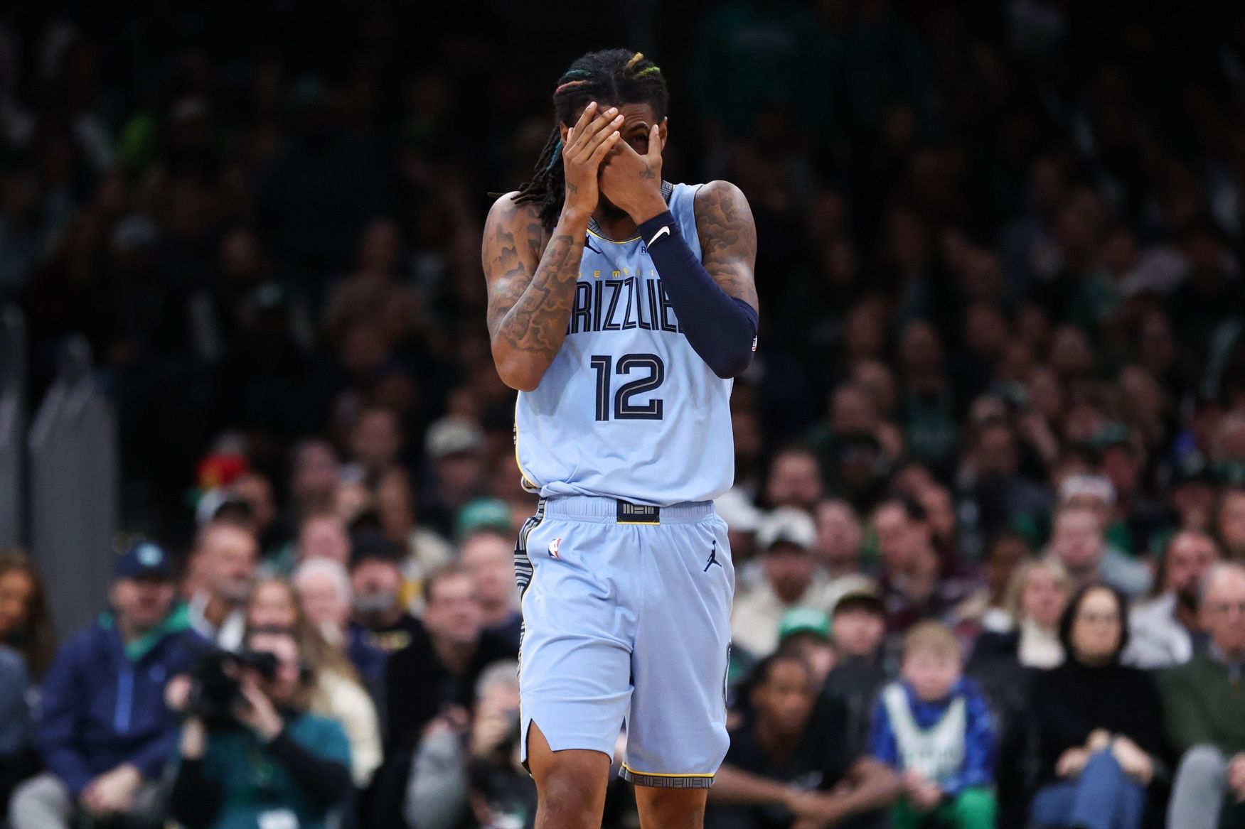Memphis Grizzlies guard Ja Morant (12) reacts after being hit in the face during the second half against the Boston Celtics at TD Garden.