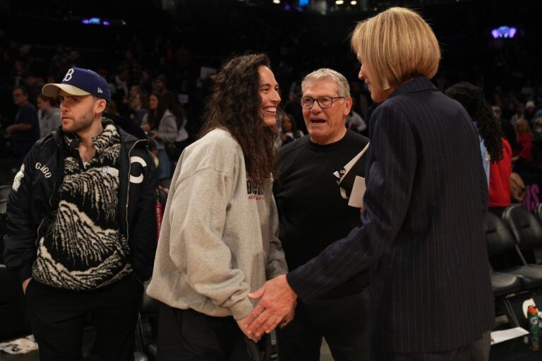 Former WNBA player Sue Bird speaks with Connecticut Huskies head coach Geno Auriemma after the game against the Louisville Cardinals at Barclays Center.