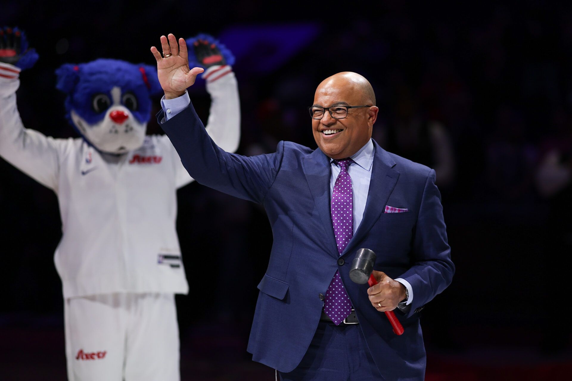 Sportscaster Mike Tirico waves to fans before a game between the Philadelphia 76ers and the Portland Trail Blazers at Wells Fargo Center.