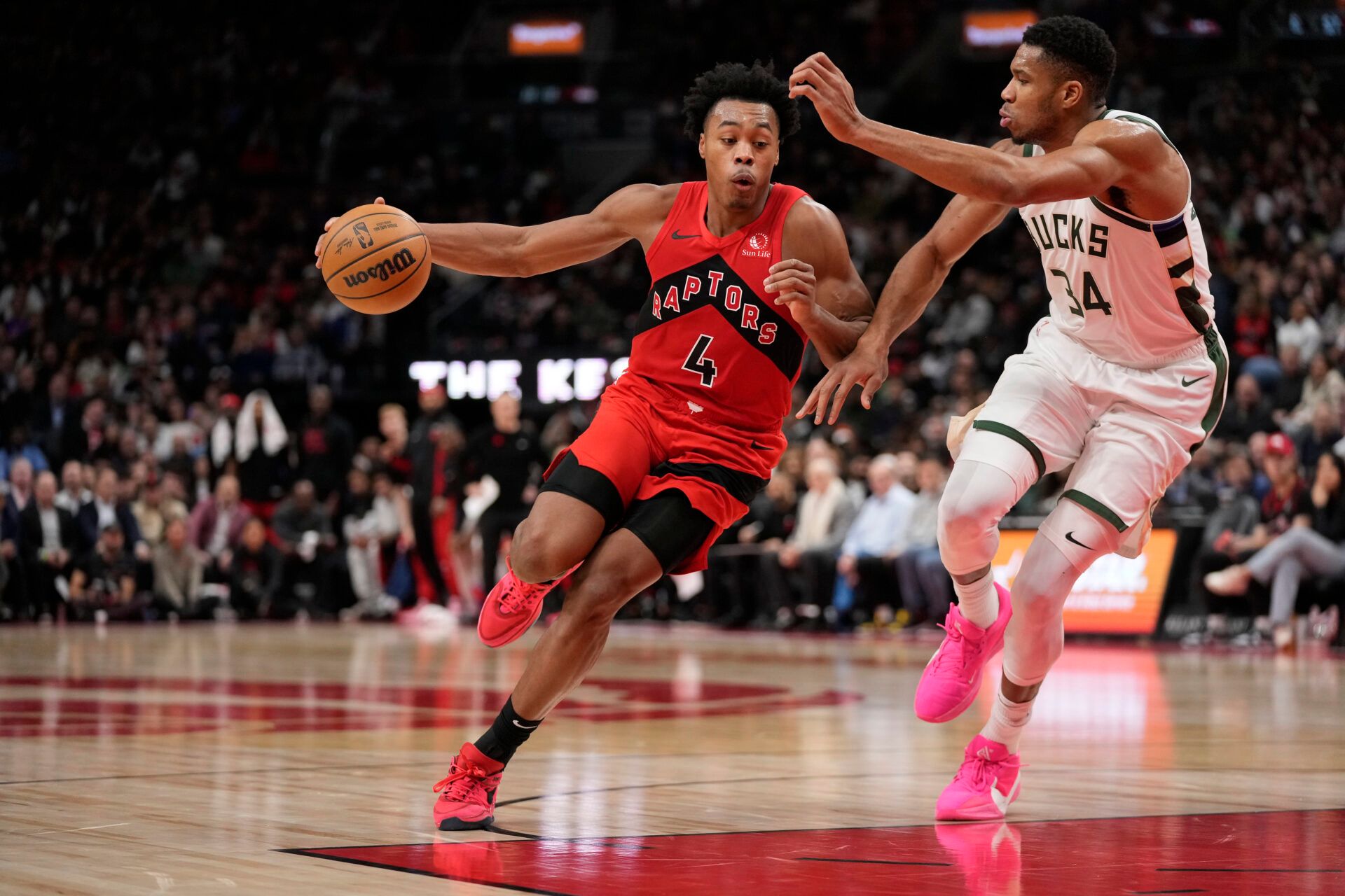 Toronto Raptors forward Scottie Barnes (4) drives to the net against Milwaukee Bucks forward Giannis Antetokounmpo (34) during the first half at Scotiabank Arena.