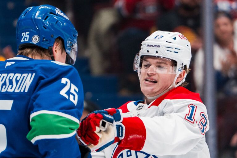 Vancouver Canucks defenseman Elias Pettersson (25) battles with Montreal Canadiens forward Cole Caufield (13) in the third period at Rogers Arena.