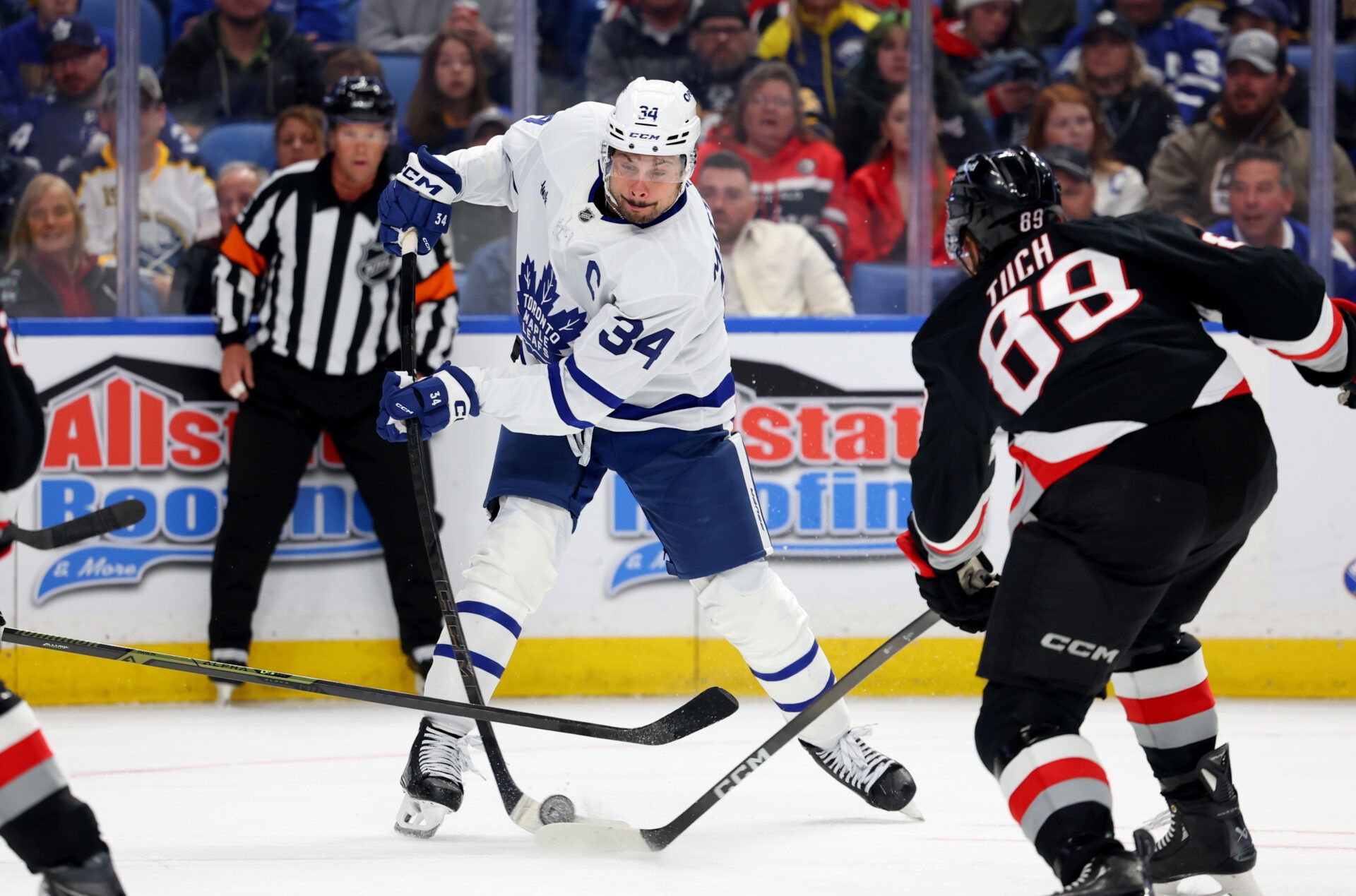 Buffalo Sabres right wing Alex Tuch (89) blocks a shot by Toronto Maple Leafs center Auston Matthews (34) with his stick during the third period at KeyBank Center.