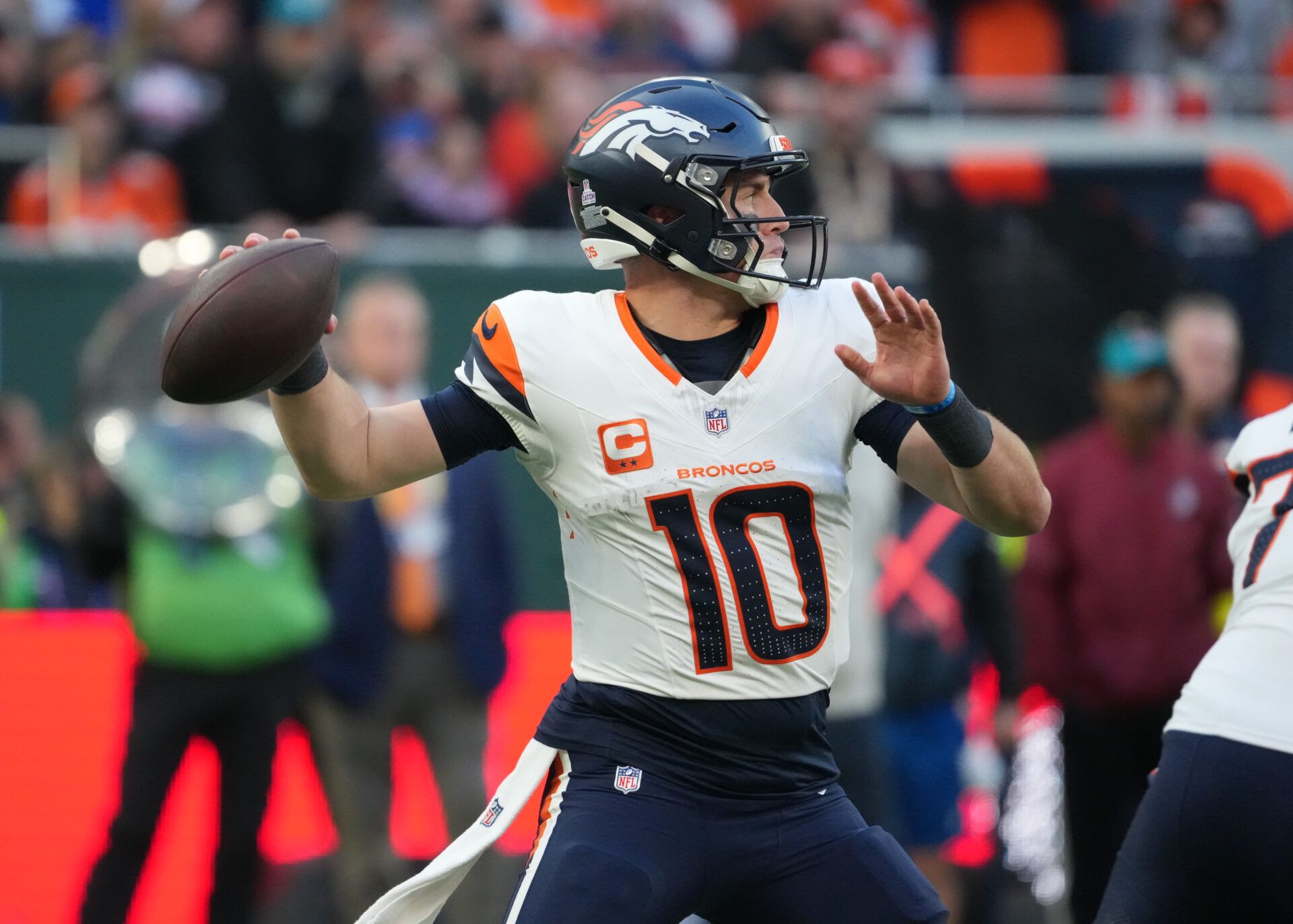 Denver Broncos quarterback Bo Nix (10) throws a pass against the New York Jets during an NFL International Series game at Tottenham Hotspur Stadium.