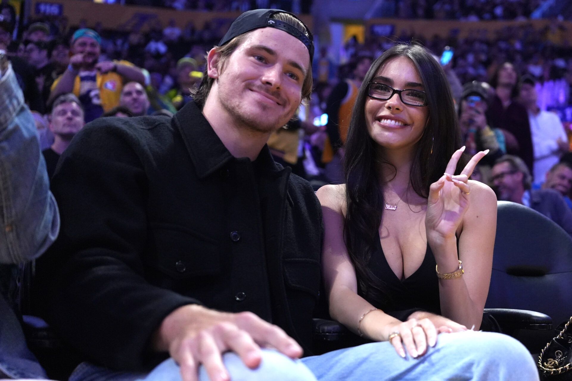 Los Angeles Chargers quarterback Justin Herbert (left) and girlfriend Madison Beer attend the game between the Minnesota Timberwolves and the Los Angeles Lakers at Crypto.com Arena.