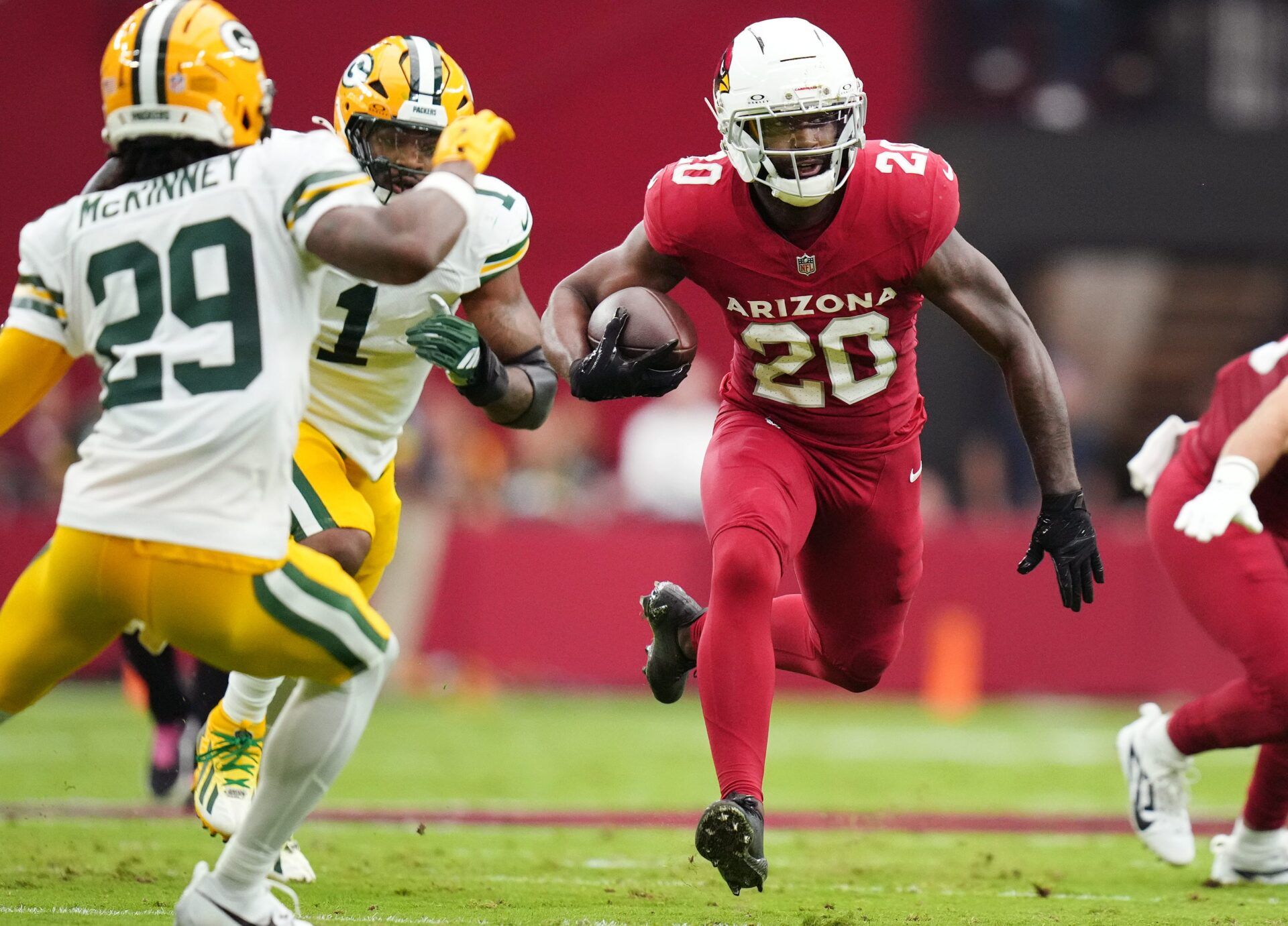 Arizona Cardinals running back Bam Knight (20) runs the ball against the Green Bay Packers at State Farm Stadium in Glendale on Oct. 19, 2025.
