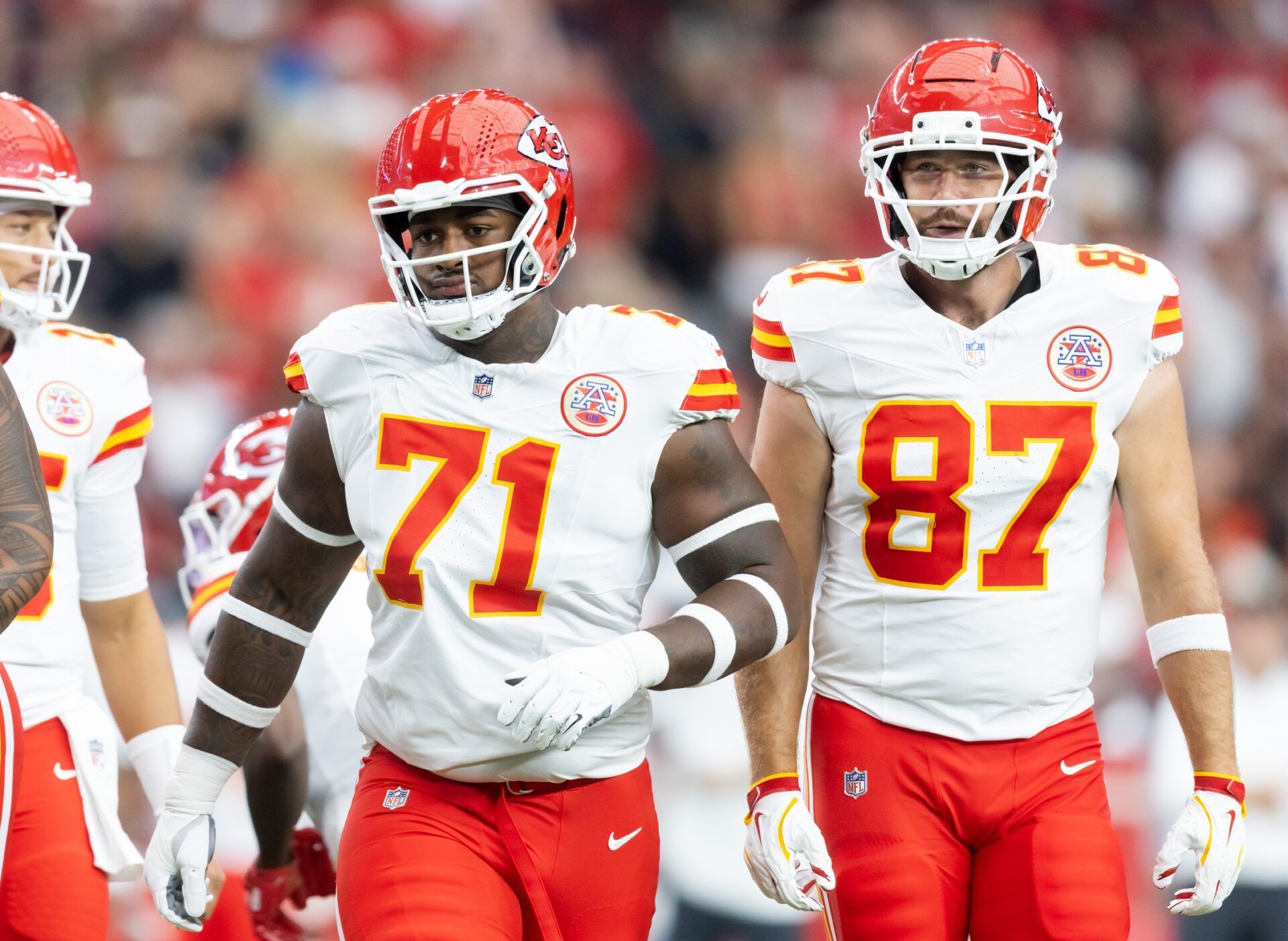 Kansas City Chiefs offensive tackle Josh Simmons (71) and tight end Travis Kelce (87) against the Arizona Cardinals during a preseason NFL game at State Farm Stadium.