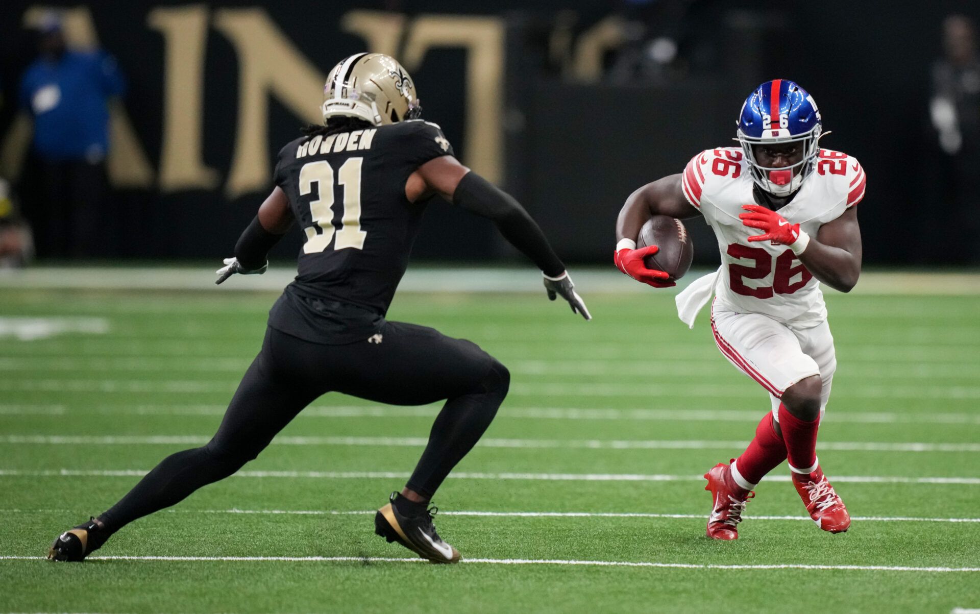 New York Giants running back Devin Singletary (26) runs the ball against New Orleans Saints safety Jordan Howden (31) at Caesars Superdome.