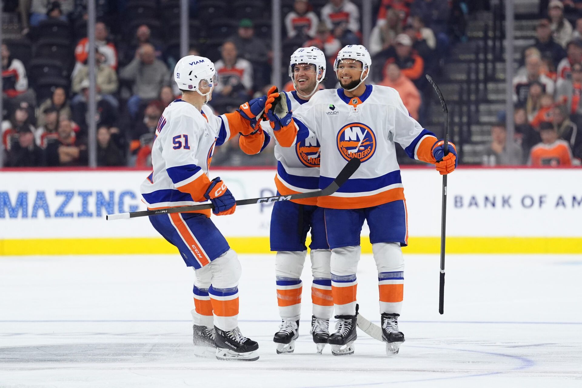 New York Islanders left wing Emil Heineman (51), defenseman Tony DeAngelo (77), and defenseman Marshall Warren (41) celebrate a goal against the Philadelphia Flyers in the third period at Xfinity Mobile Arena.